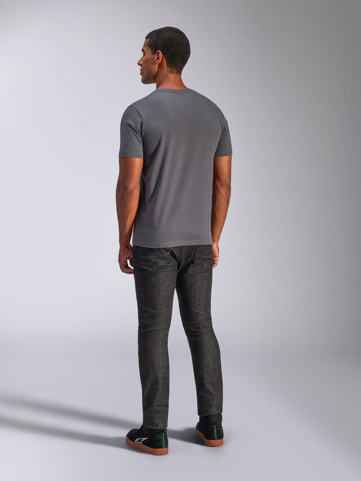 Alpinestars Always 2.0 CSF Tee, kortärmad t-shirt, mörkgrå, ryggvy på modell, matchad med mörka denimbyxor och svarta sneakers, avslappnat motorsportinspirerat streetwear
