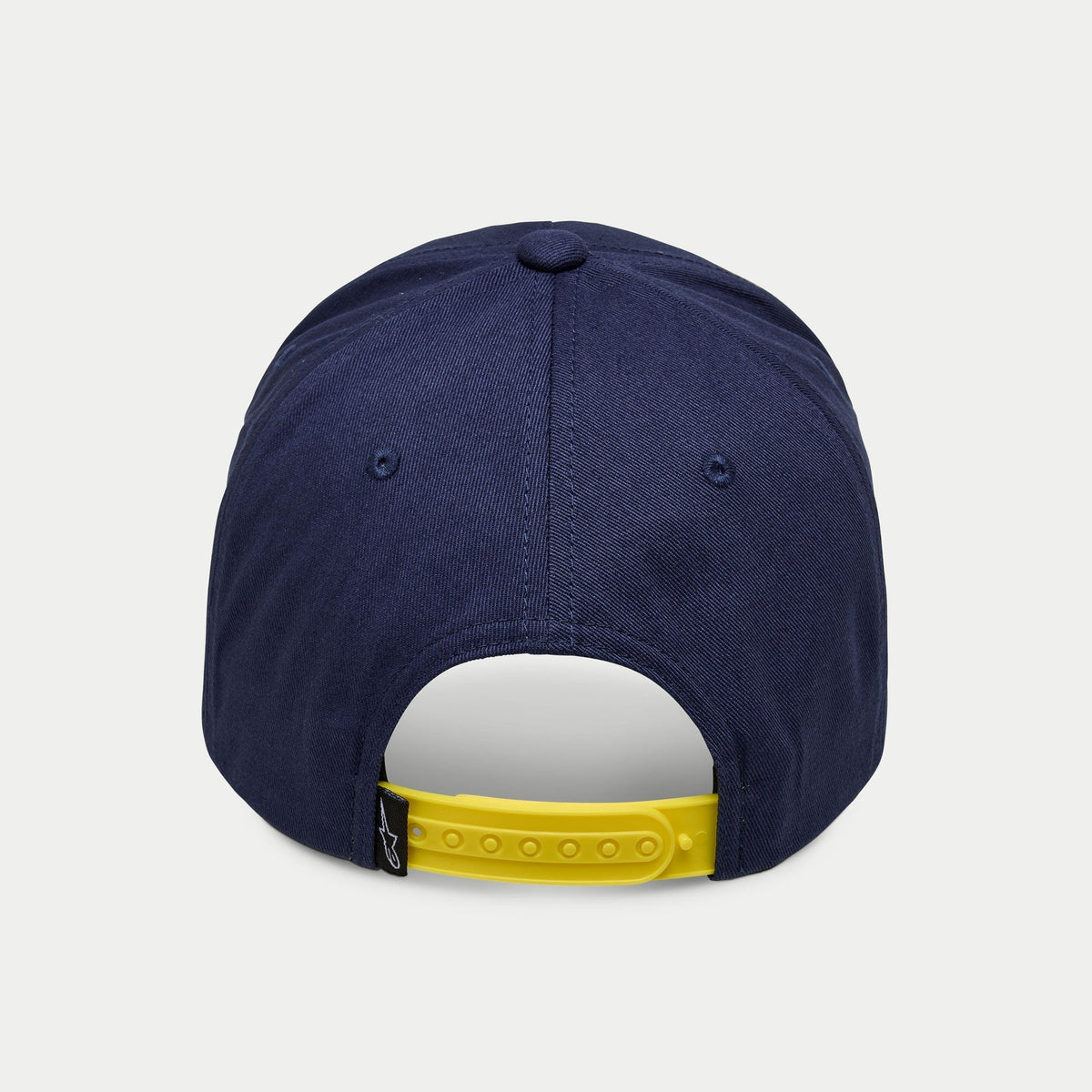 Alpinestars Par Hat, marinblå snapback-keps, vy bakifrån med en klargul justerbar rem och en liten svart logotypflik, strukturerad krona i marinblå bomullstwill, avslappnad sportkeps