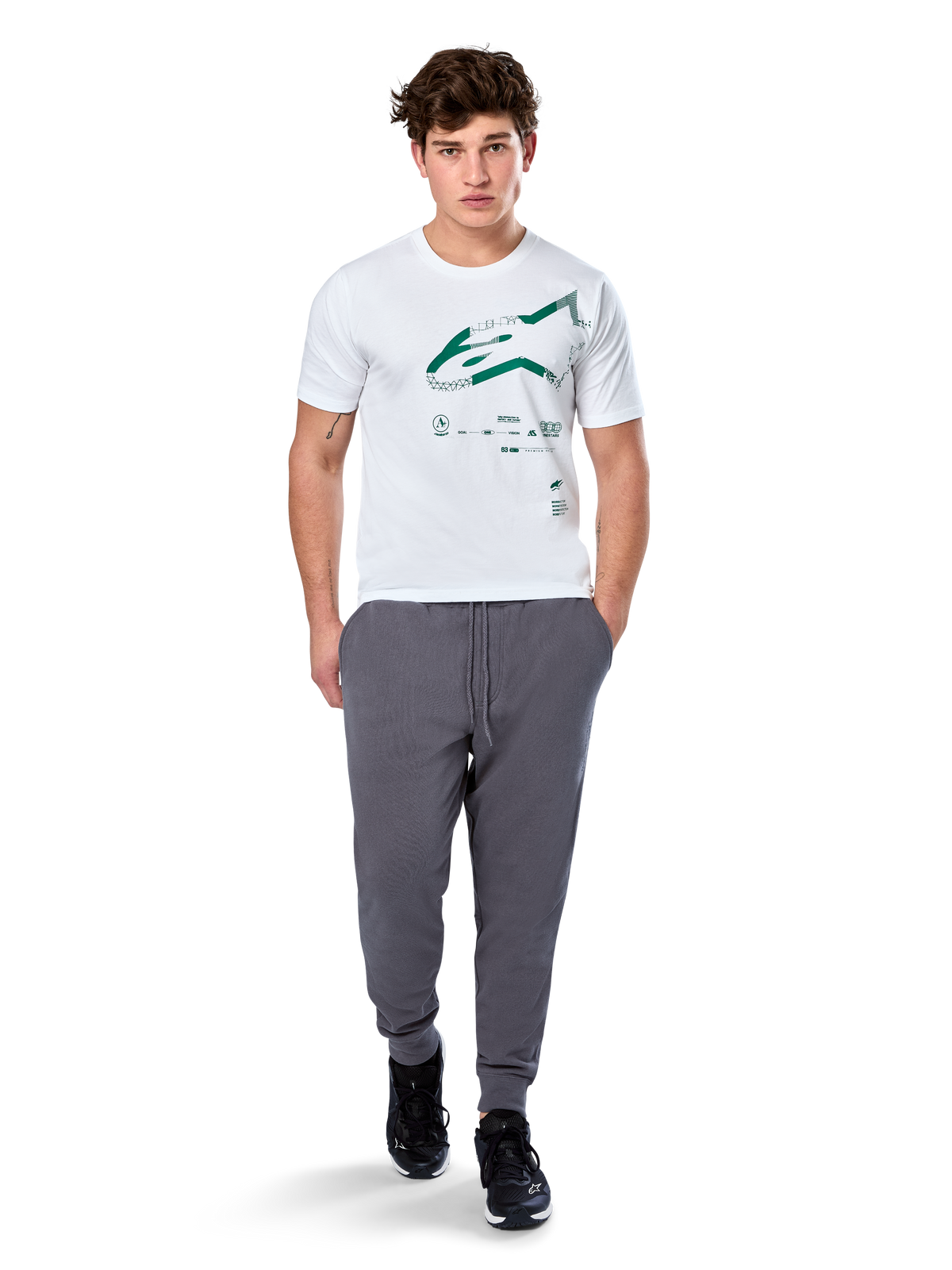 Alpinestars Geografica CSF Tee, Short Sleeve T-Shirt, White, Green Astars Logo with geographic multi-tech graphic, worn with grey sweatpants and black sneakers, casual motorsport streetwear