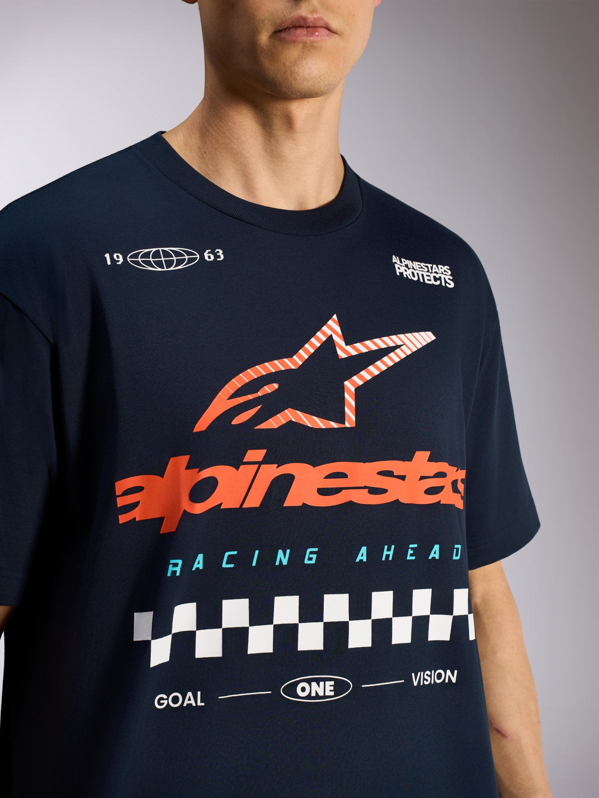 Alpinestars Aplomb Oversized CSF Tee, kortärmad t-shirt, marinblå, med stor orange-randig Astars-stjärnlogotyp och rutig racinggrafik, vardagliga motorsportkläder