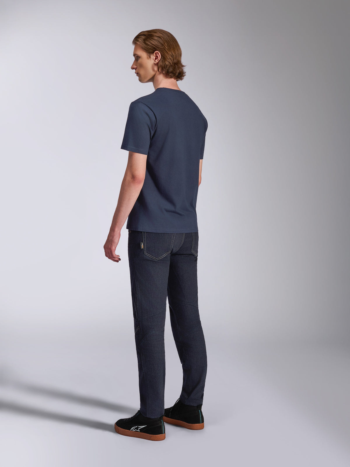 Alpinestars Fasting CSF Tee, Short Sleeve T-Shirt, Navy Blue, back view on model, paired with dark denim pants and black sneakers, casual motorsport-inspired streetwear