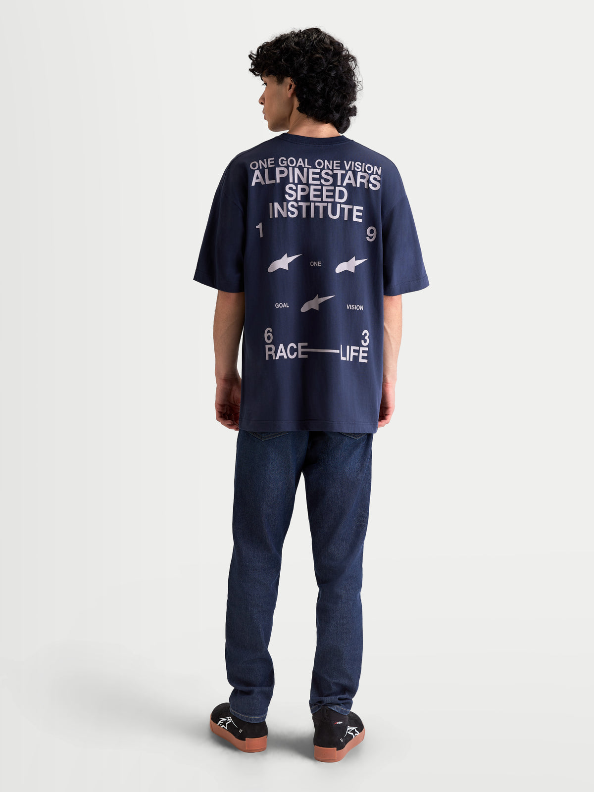Alpinestars Institute Oversized SS CSF t-shirt, mörkblå kortärmad t-shirt med stor vit grafik på ryggen, texten Alpinestars Speed Institute och slogan One Goal One Vision, avslappnad oversized passform, baksidan på modell.