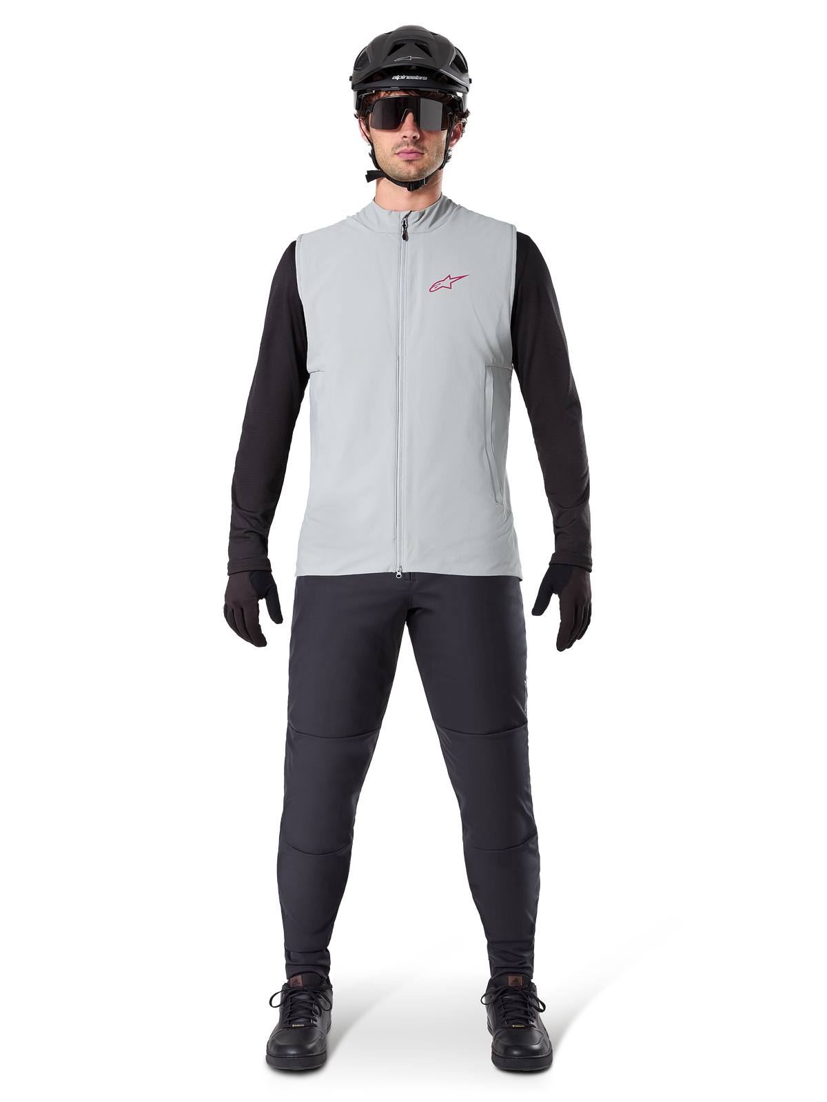 Alpinestars A-Dura Thermal Vest, cykelväst, Titanium Gray, bärs med svart långärmad tröja och svarta byxor, svart hjälm och solglasögon, röd Alpinestars-logotyp, lätt termisk isolering för mountainbike