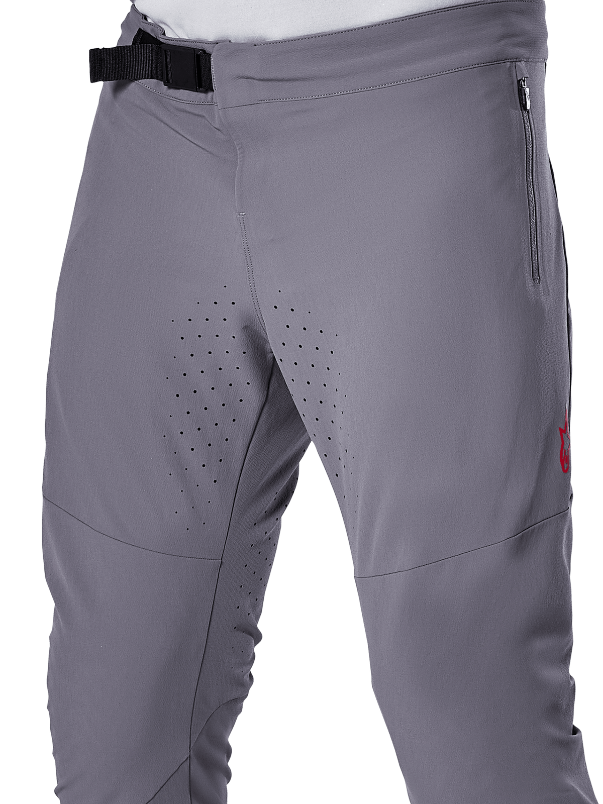 Alpinestars A-Aria Elite byxor, MTB-cykelbyxor, mörkgrå, närbild som visar magnetiskt spänne, blixtlåsförsedd sidoficka och laserskurna ventilationsperforeringar på innerlåren för prestanda vid trailcykling
