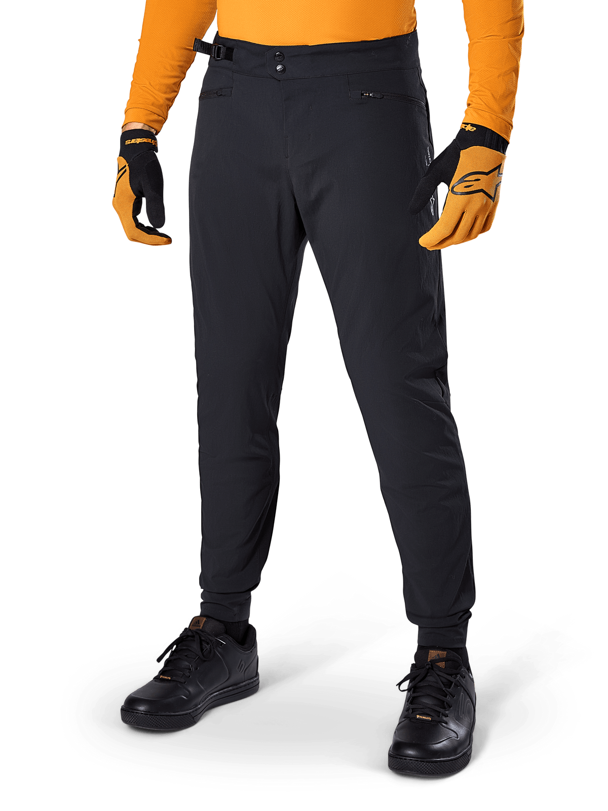 Alpinestars A-Dura Pants, Mountain Bike Pants, Black, side waist cinches and zippered pockets, worn with orange jersey and gloves, sporty regular fit for MTB riding