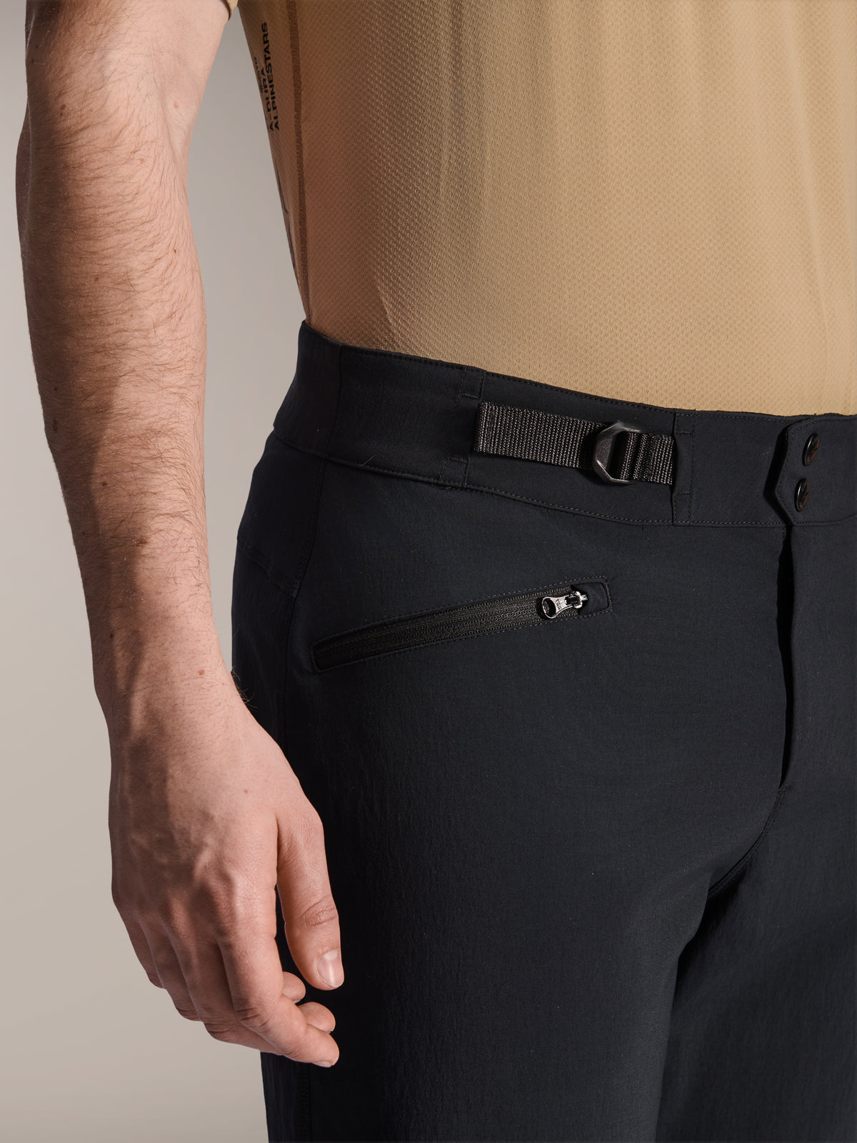 Alpinestars A-Dura Shorts, svarta MTB-shorts, närbild som visar dragkedjeförsedd ficka och justerbar sidorem, dubbelknäppning, slitstarkt material för mountainbike