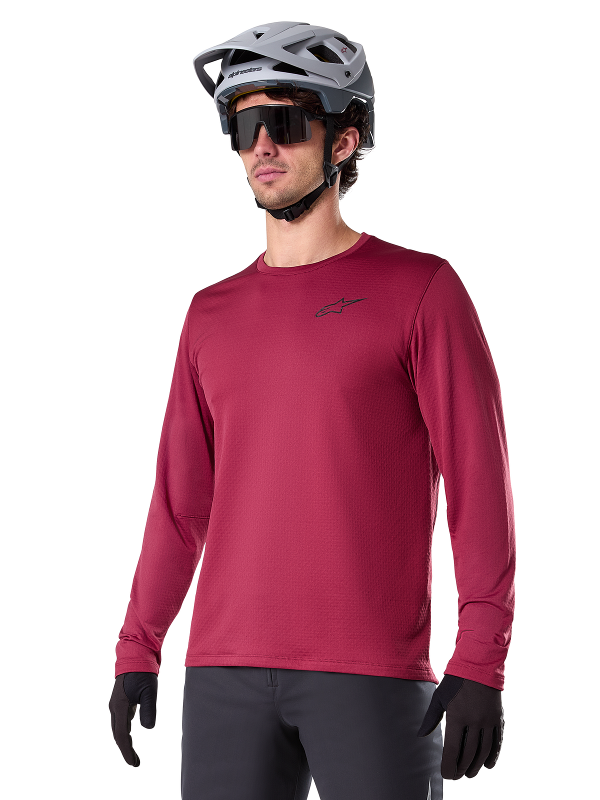 Alpinestars A-Dura Thermal Jersey, Long-Sleeve Mountain Biking Jersey, Burgundy Red, featuring insulated fleece lining and small black chest logo, worn with a gray helmet, black sunglasses, and black gloves, designed for cold-weather cycling