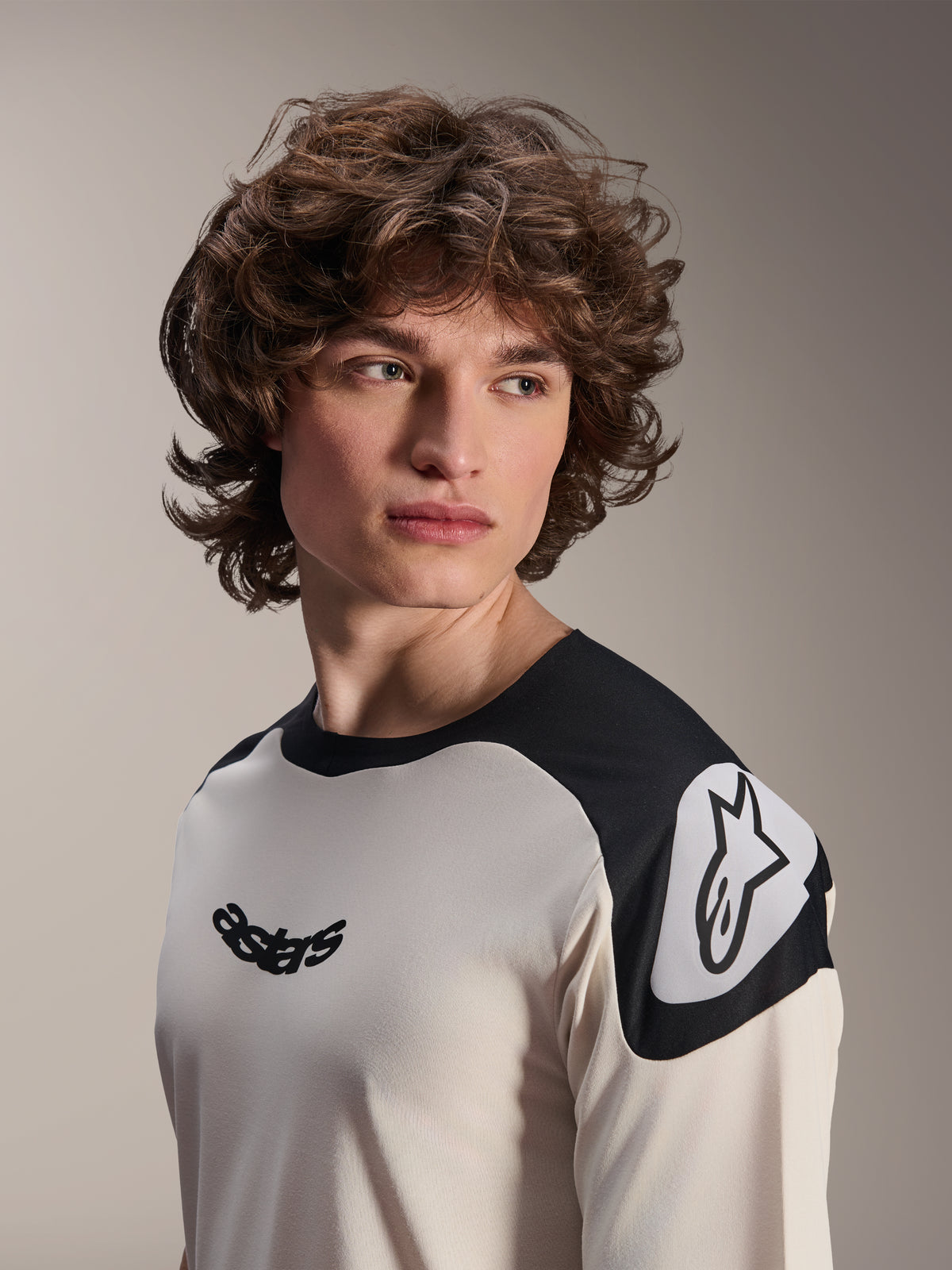 Alpinestars A-Aria Polartec Elite Short Sleeve Jersey, Ecru with black shoulder panels, featuring black astars logo on chest and white Astars logo on shoulder, high-performance mountain bike gear worn by model