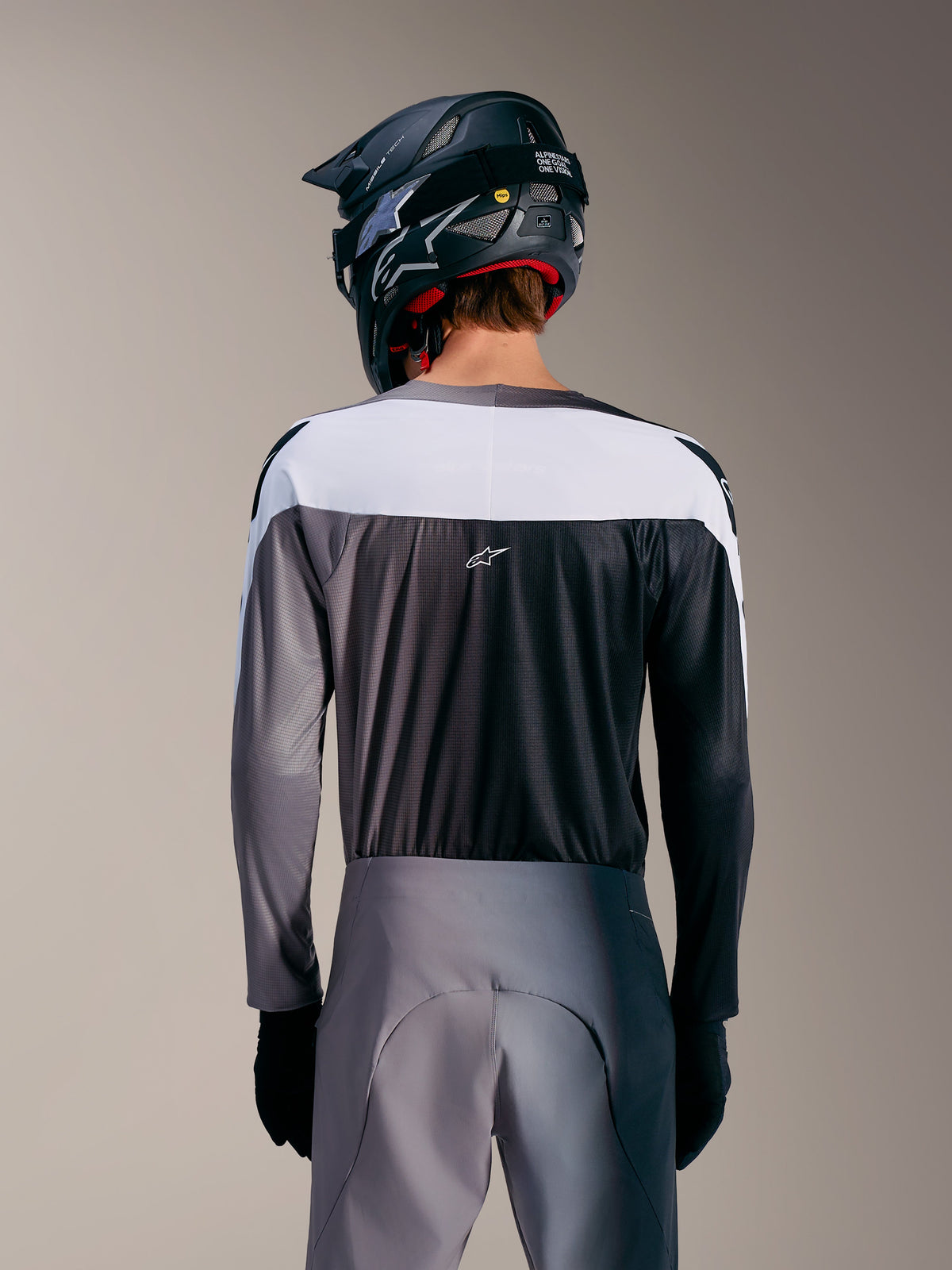 A-Supra Elite Jersey in Faded Gray, rear view featuring white upper panel, micro-perforated fabric, and centered ASTARS logo.
