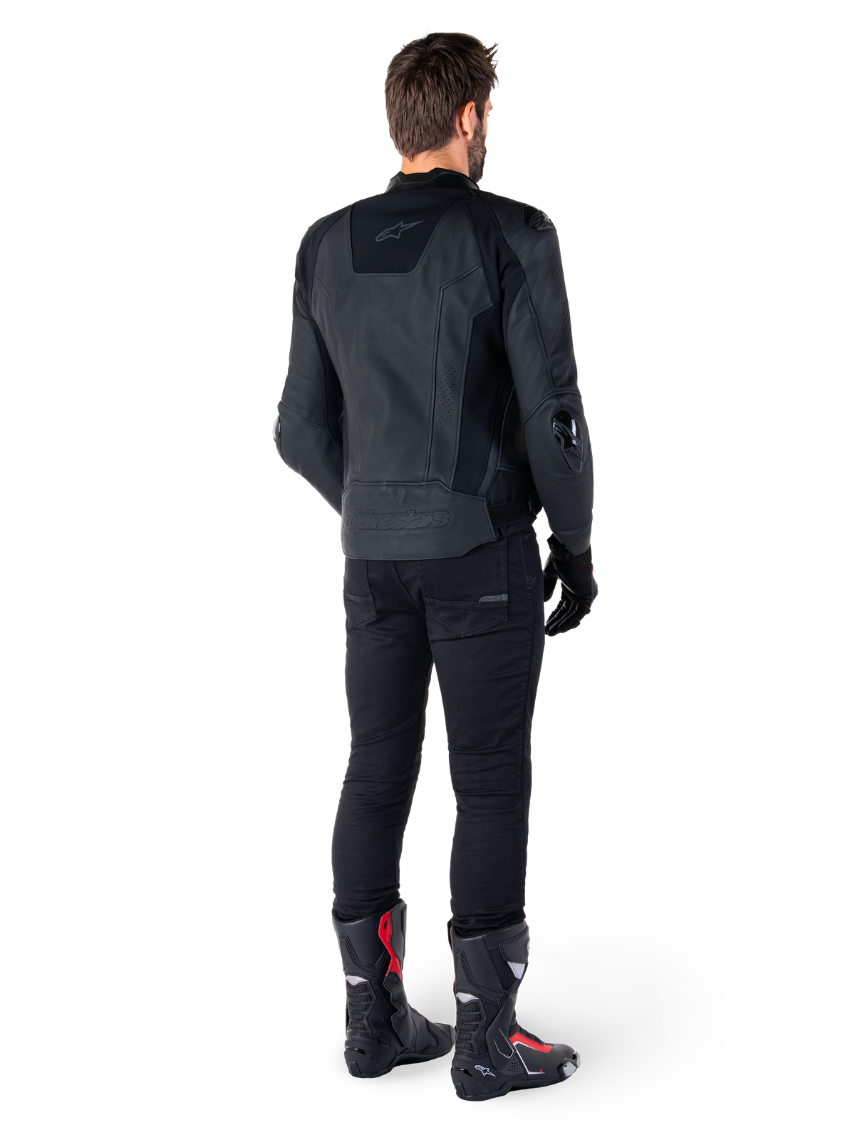 Alpinestars Missile V3 Leather Jacket in Black, rear view on a rider, worn with black pants and black and red racing boots, featuring sleek leather construction with tonal branding and a performance race fit