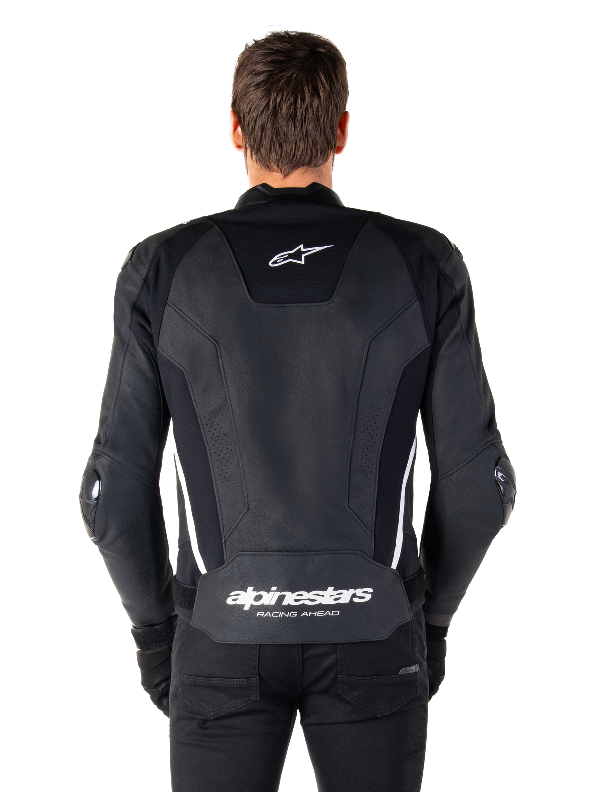 Ryggvy av Alpinestars Missile V3 skinnjacka i svart och vitt, med Alpinestars stjärnlogotyp på övre delen av ryggen och branding på ländryggen, vita vertikala ränder och externa armbågssliders, premium racing-sportjacka i skinn