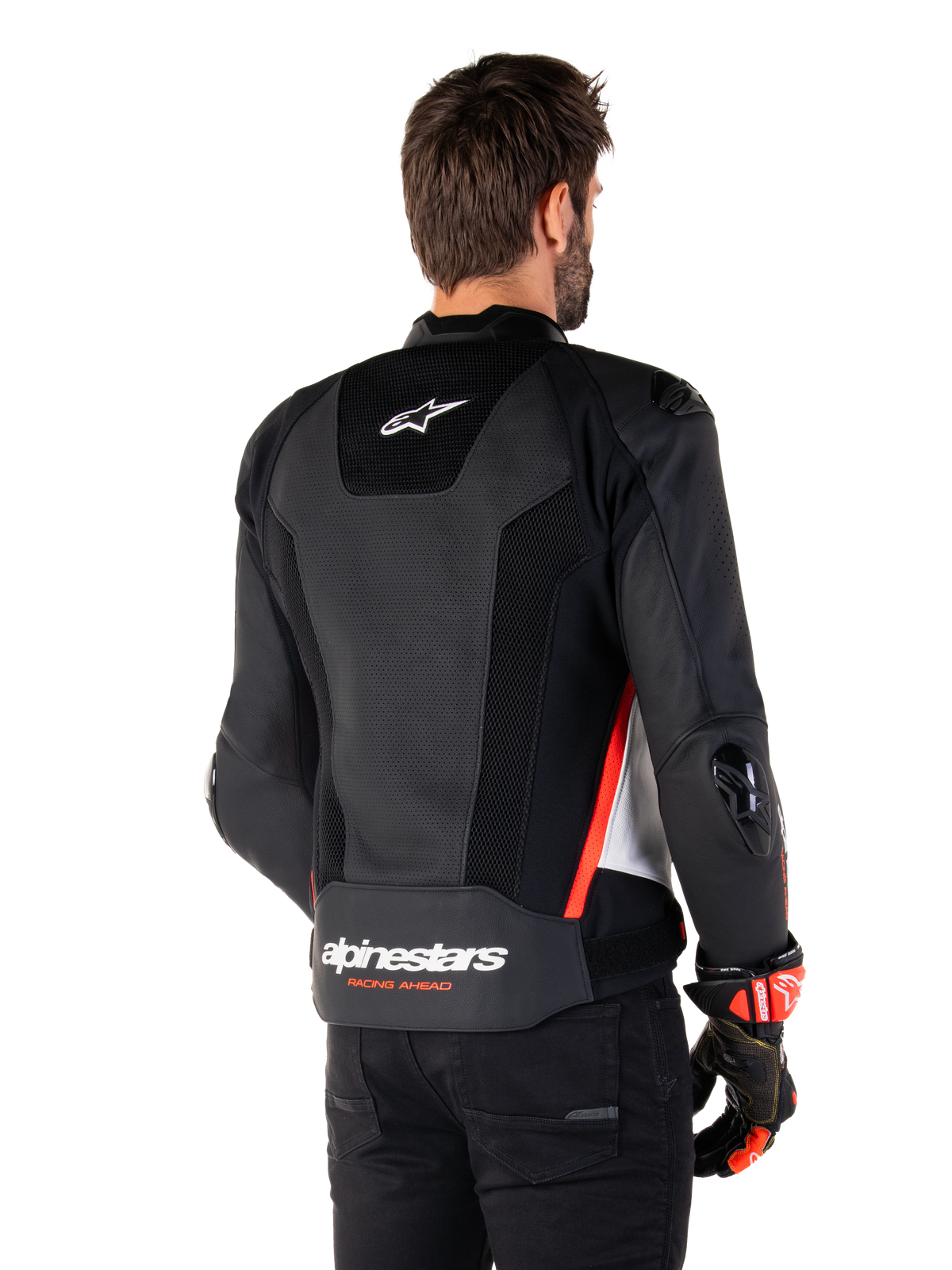 Alpinestars Missile V3 Airflow läderjacka, sedd bakifrån, svart, vit och röd fluo, omfattande perforeringar för ventilation, externa DFS-sliders på axlar och armbågar, Alpinestars-logotyp på nedre delen av ryggen