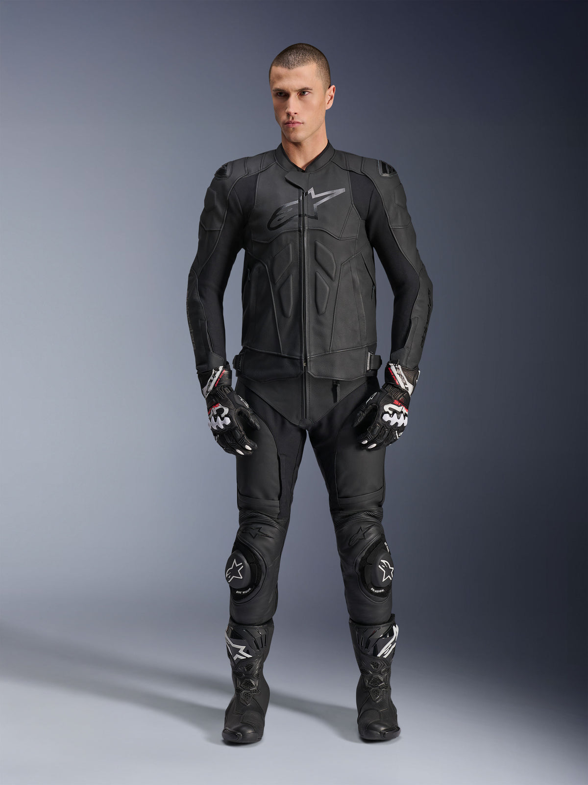 Alpinestars Dusk Leather Jacket, black bovine leather sport motorcycle jacket, worn by male model in full racing gear.