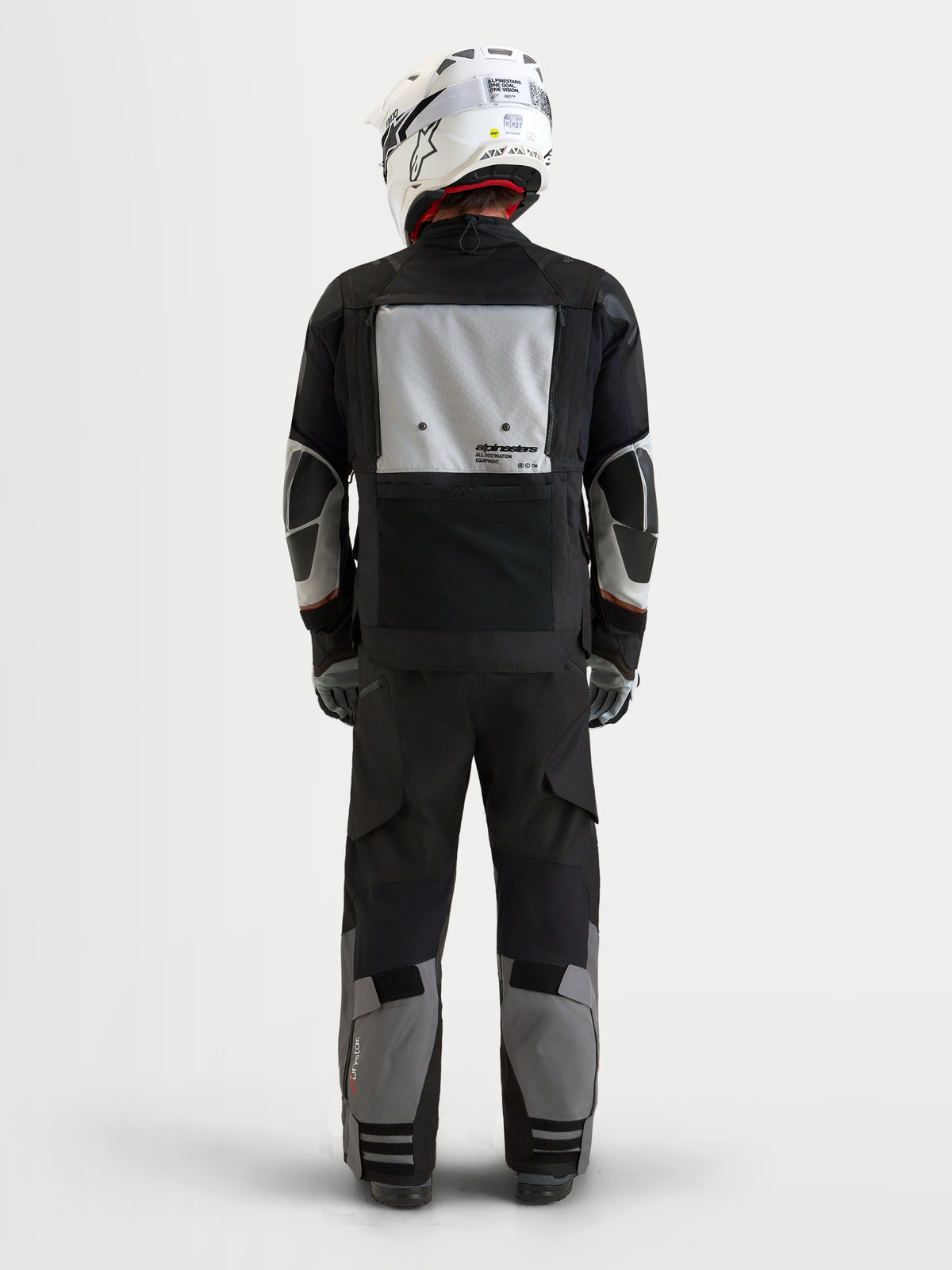 Alpinestars Harok V2 Drystar Gear Set, motorcycle touring jacket and pants in black and gray, rear view on a model wearing a matching white helmet, waterproof textile construction with adventure riding features