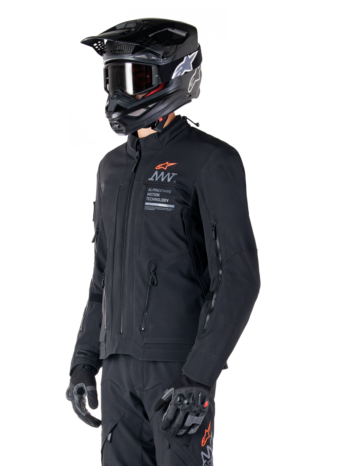 Alpinestars AMT-8 Stretch Drystar® XF Jacket, Black, worn by a rider with matching adventure pants and gloves, featuring a black motocross helmet and goggles, zippered ventilation ports on the chest and arms, Alpinestars Motion Technology branding with an orange logo, premium adventure-touring gear
