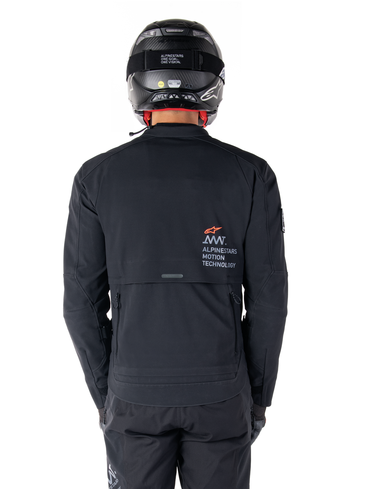 Alpinestars AMT-8 Stretch Drystar® XF Jacket, Rear View, Black, worn with a black helmet and pants, featuring Alpinestars Motion Technology branding on the back, adventure touring design with ergonomic stretch material.