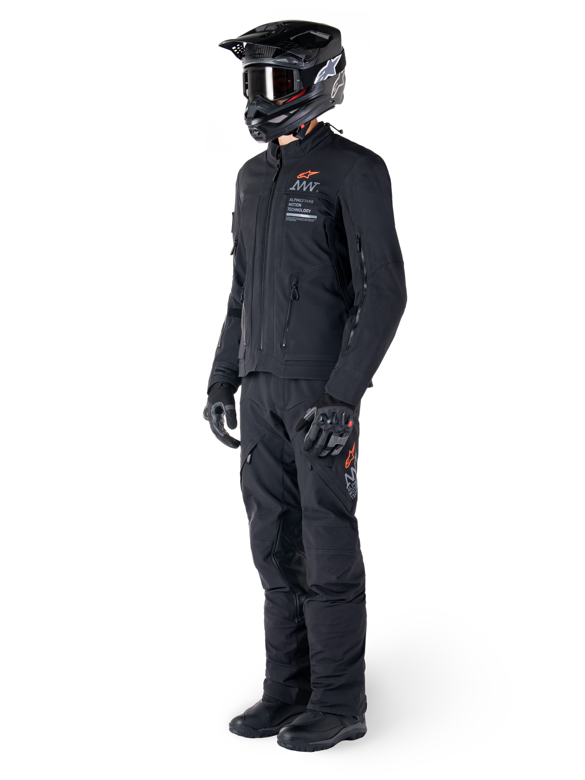 Alpinestars AMT-8 Stretch Drystar® XF Jacket, Adventure Motorcycle Jacket, Black, worn with matching pants, helmet, and gloves, featuring Alpinestars Motion Technology branding with orange accents, durable stretch construction for adventure riding