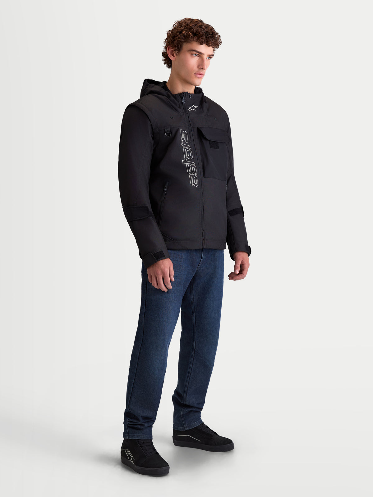 Alpinestars Morfex Parka Waterproof Jacket, men's urban contemporary textile motorcycle jacket in black, three-quarter view on a model wearing the modular jacket with integrated hood and streetwear styling