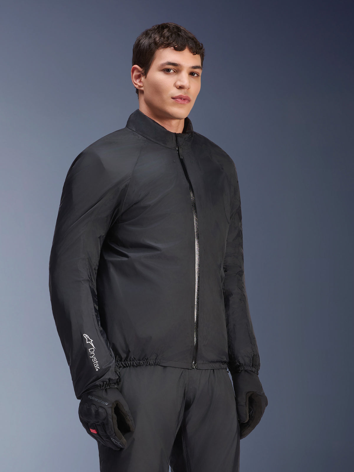 Alpinestars Andes Air Drystar® vattentätt membran, svart, bärs av en manlig modell med svarta handskar och byxor, lätt teknisk textil med 'Drystar'-logotyp på ärmen, studiobild