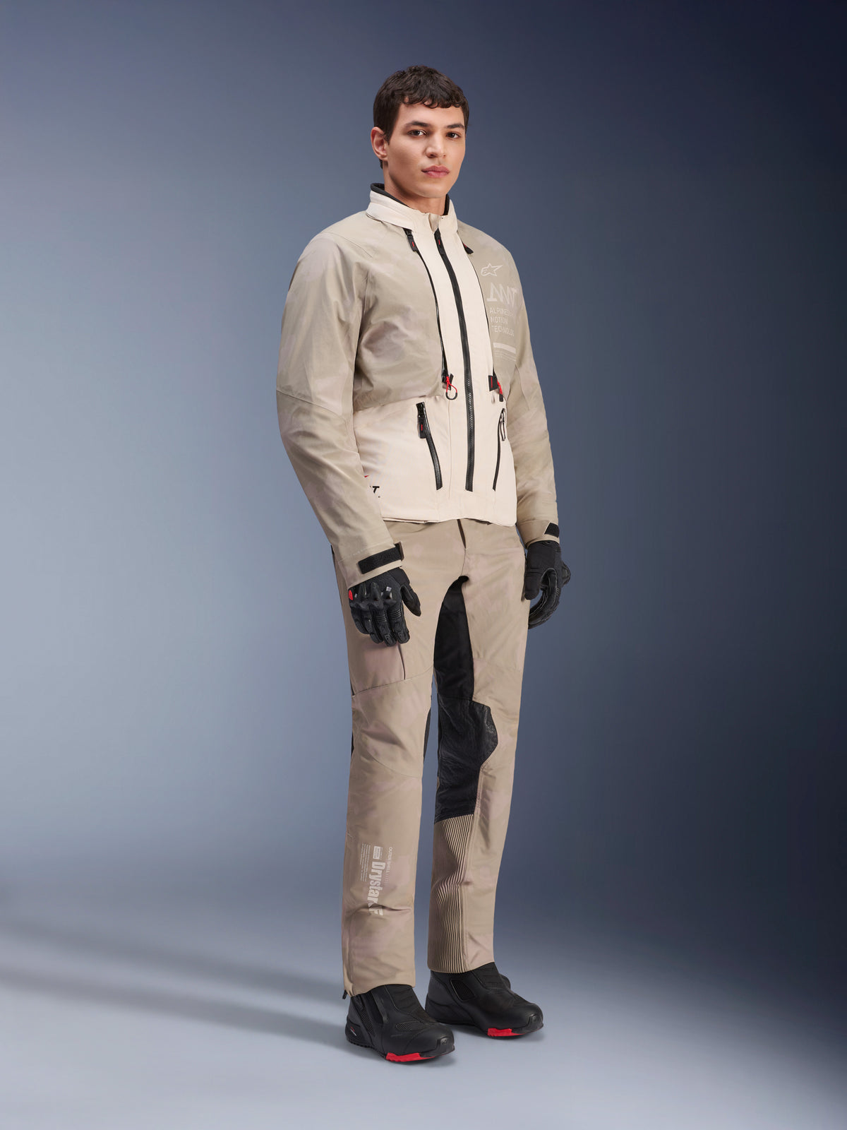 Alpinestars AMT-10LAB Drystar® XF Jacket, Adventure Motorcycle Jacket, White Sand Aluminum Camo, worn with matching adventure pants, black motorcycle gloves and boots, full-body studio shot, multi-season protective riding gear