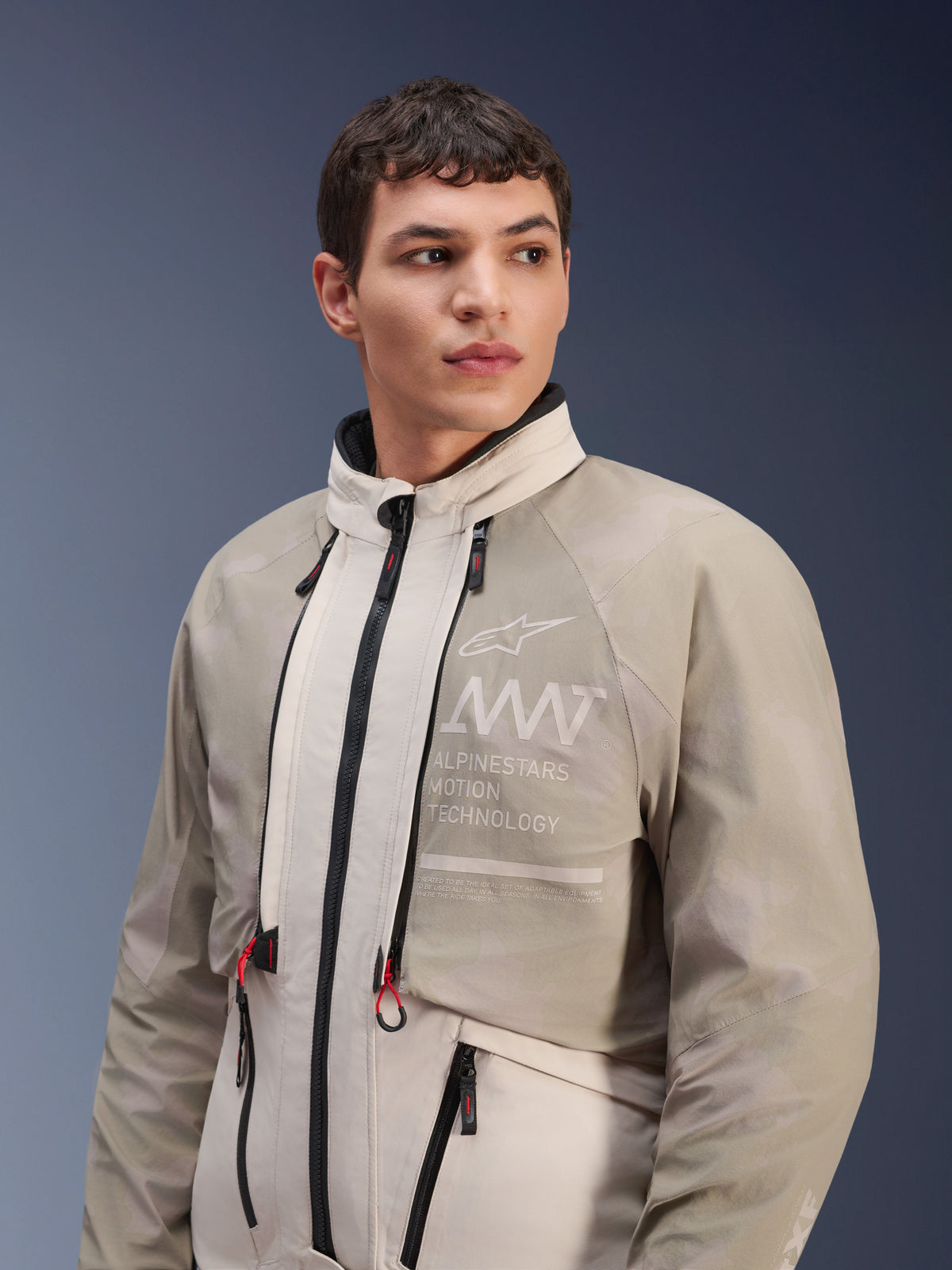Alpinestars AMT-10LAB Drystar® XF Jacket, White Sand Aluminum Camo, modular adventure motorcycle jacket, featuring "Alpinestars Motion Technology" branding on the chest, worn by a male model.