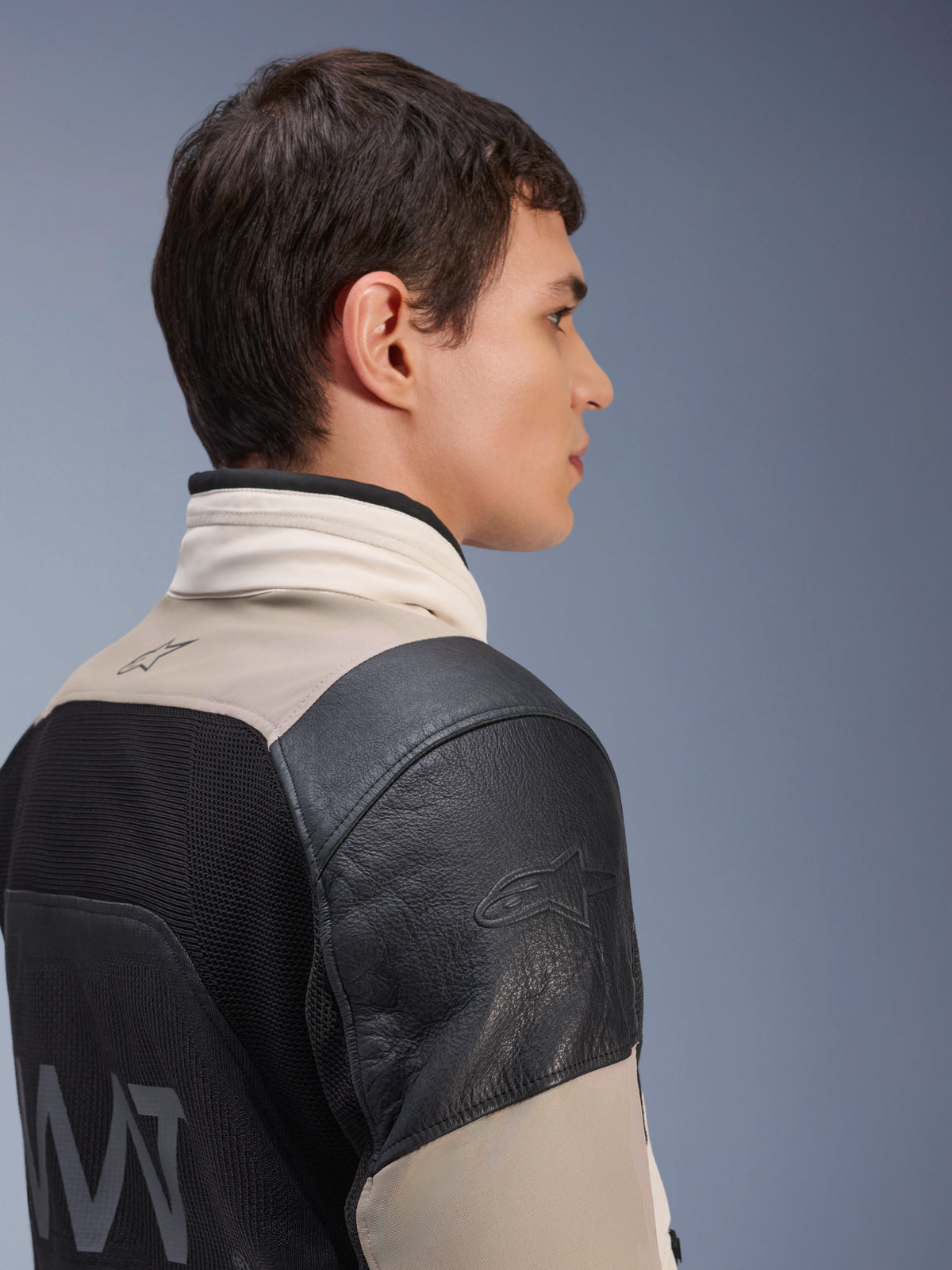 Alpinestars AMT-10LAB Drystar® XF Jacket, Adventure Motorcycle Jacket, White Sand and Black, side profile showing black leather shoulder with embossed logo, MATYRX® mesh back panel with AMT branding, modular all-weather protective design.