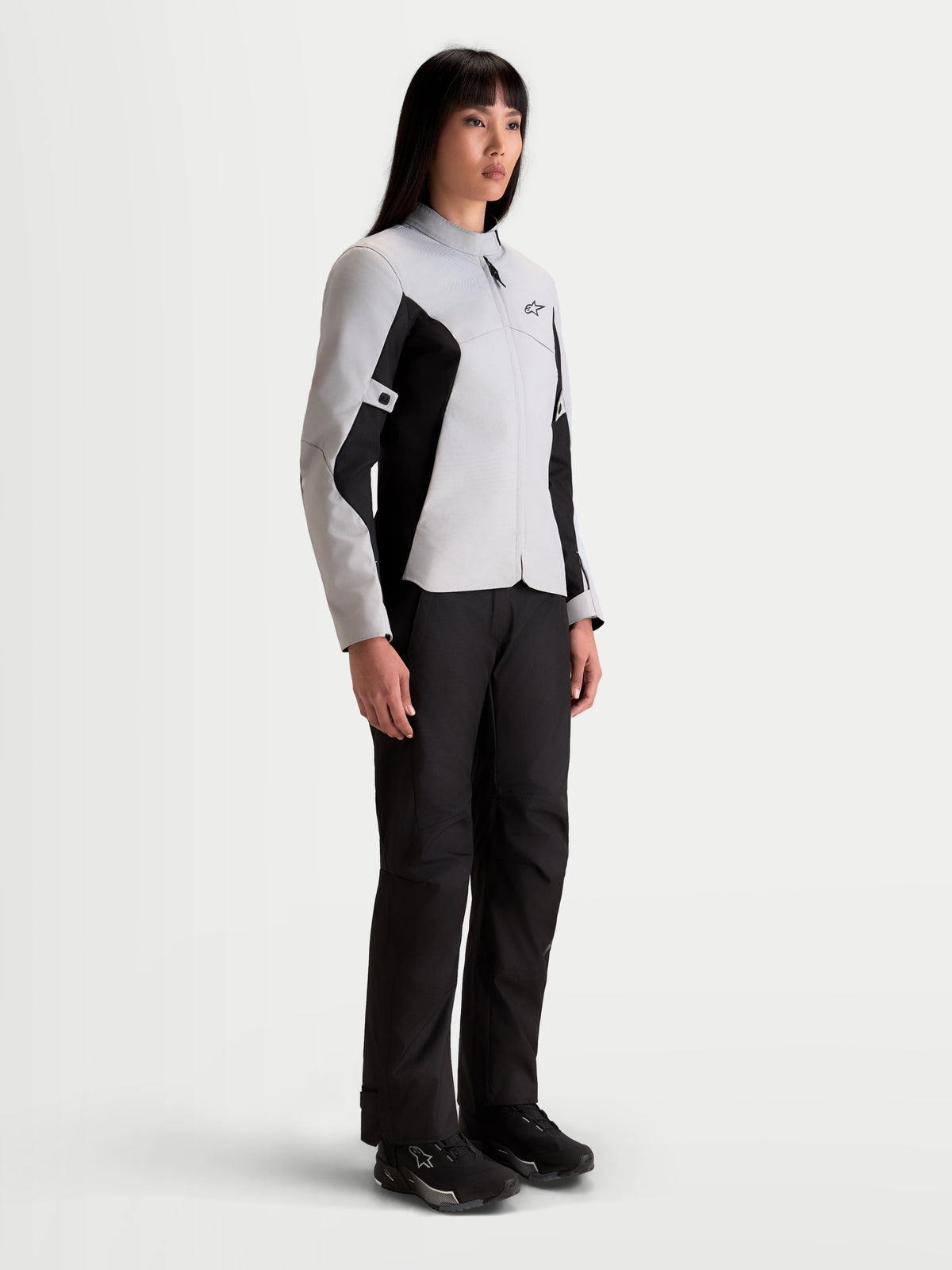 Alpinestars Stella C-1 Waterproof Jacket, women's urban motorcycle textile jacket in ice gray and black, worn by a model showing the waterproof commuter fit and soft collar construction