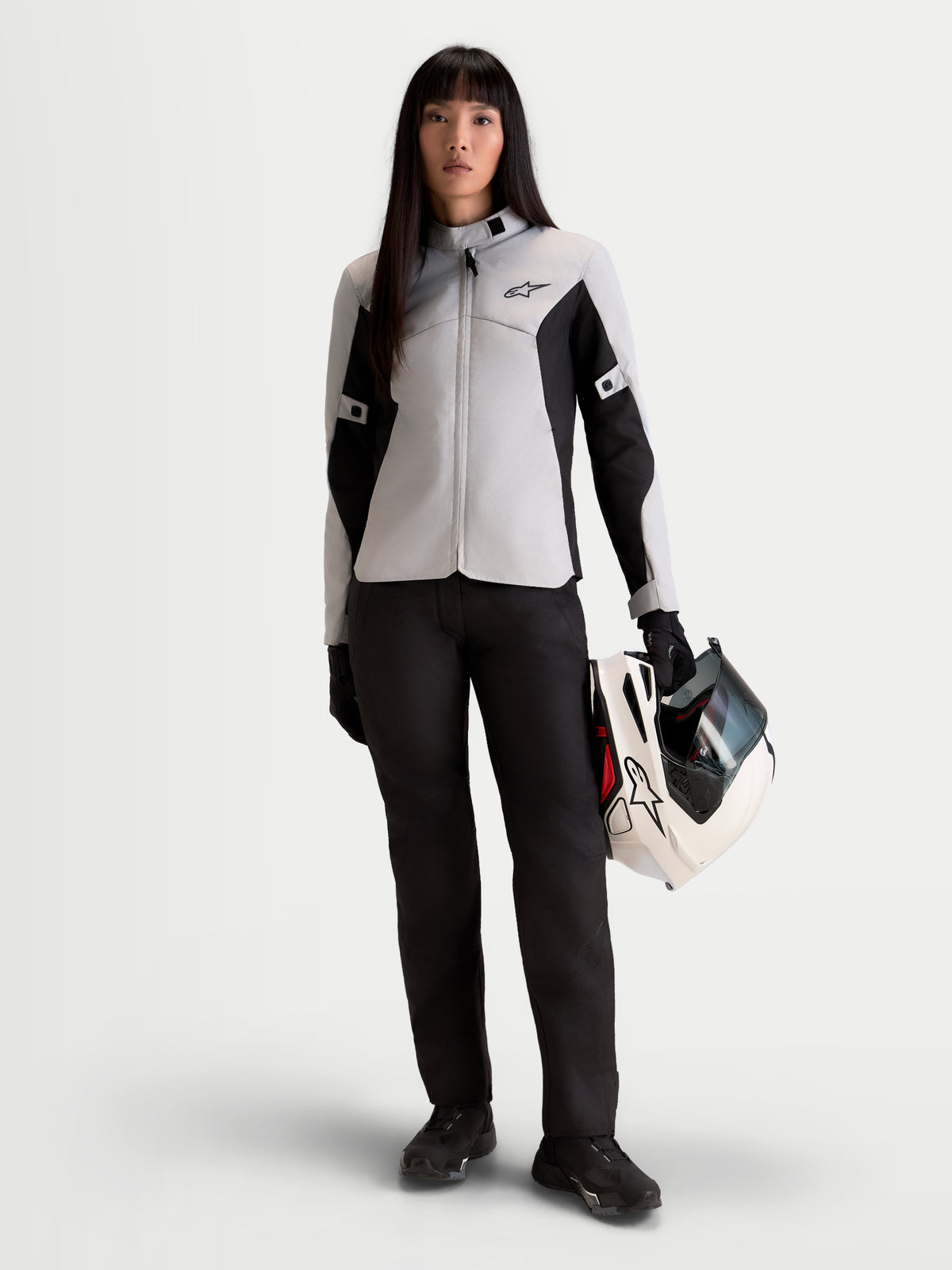 Alpinestars Stella C-1 Waterproof Jacket, women's urban motorcycle jacket in ice gray and black, front view worn by a model holding a matching helmet, textile commuter riding apparel.