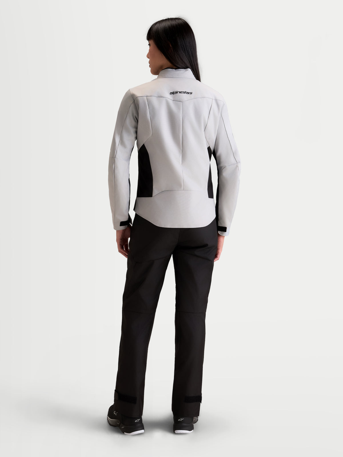 Alpinestars Stella C-1 Waterproof Jacket, women's urban motorcycle textile jacket in ice gray and black, rear view on a model showing 3D back construction and waterproof textile design.
