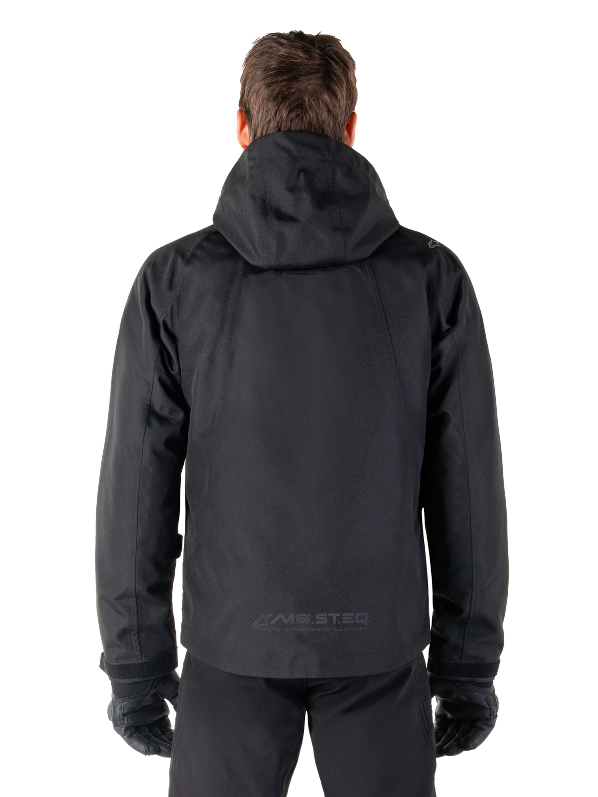 Alpinestars Morush vattentät parka, svart urban herr-MC-jacka, vy bakifrån med huva och reflekterande MO.ST.EQ.-logotyp.