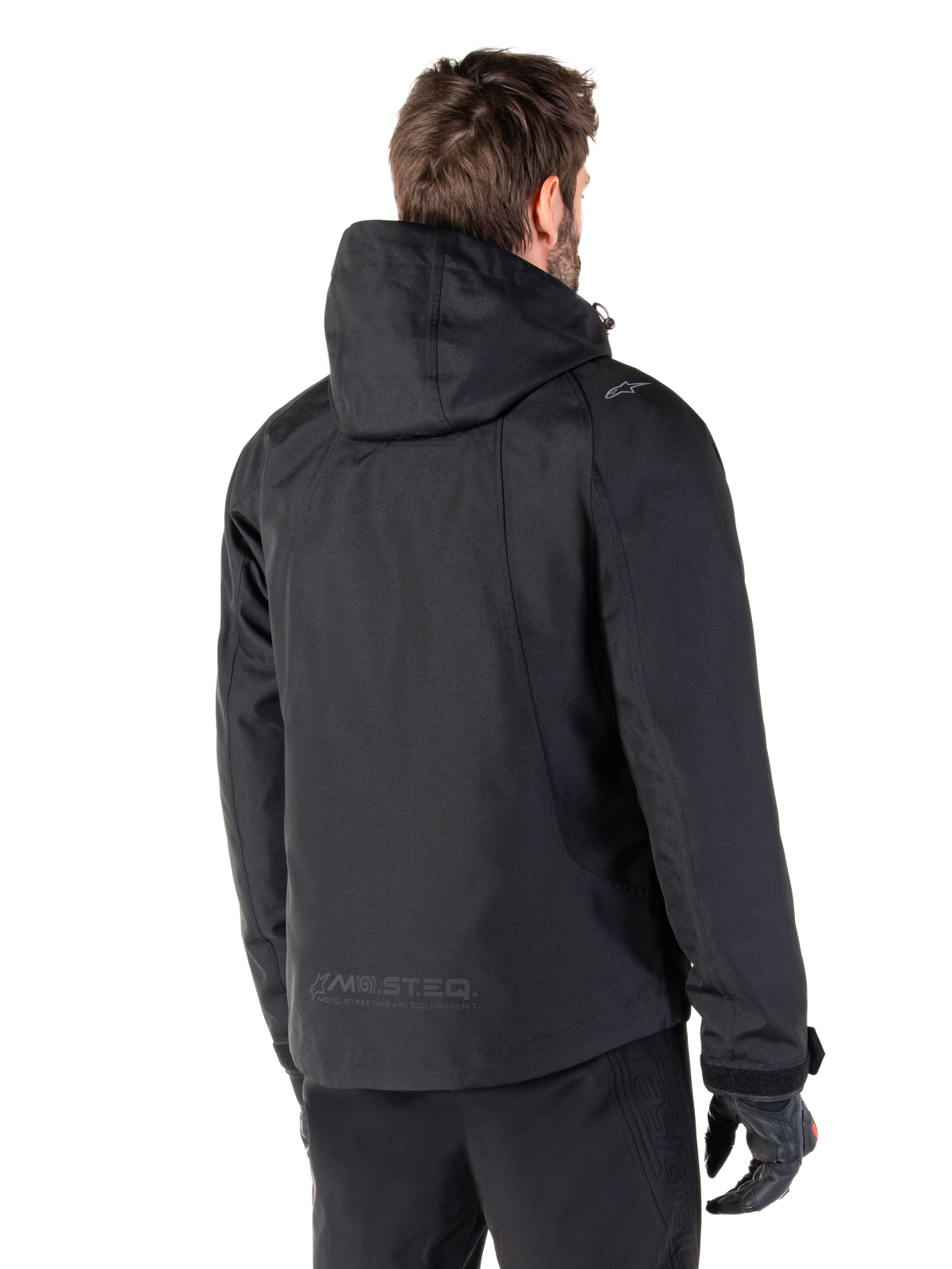 Alpinestars Morush Vattentät Parka, svart urban motorcykeljacka för herr, bakifrånvy med huva och MO.ST.EQ.-logotyp.