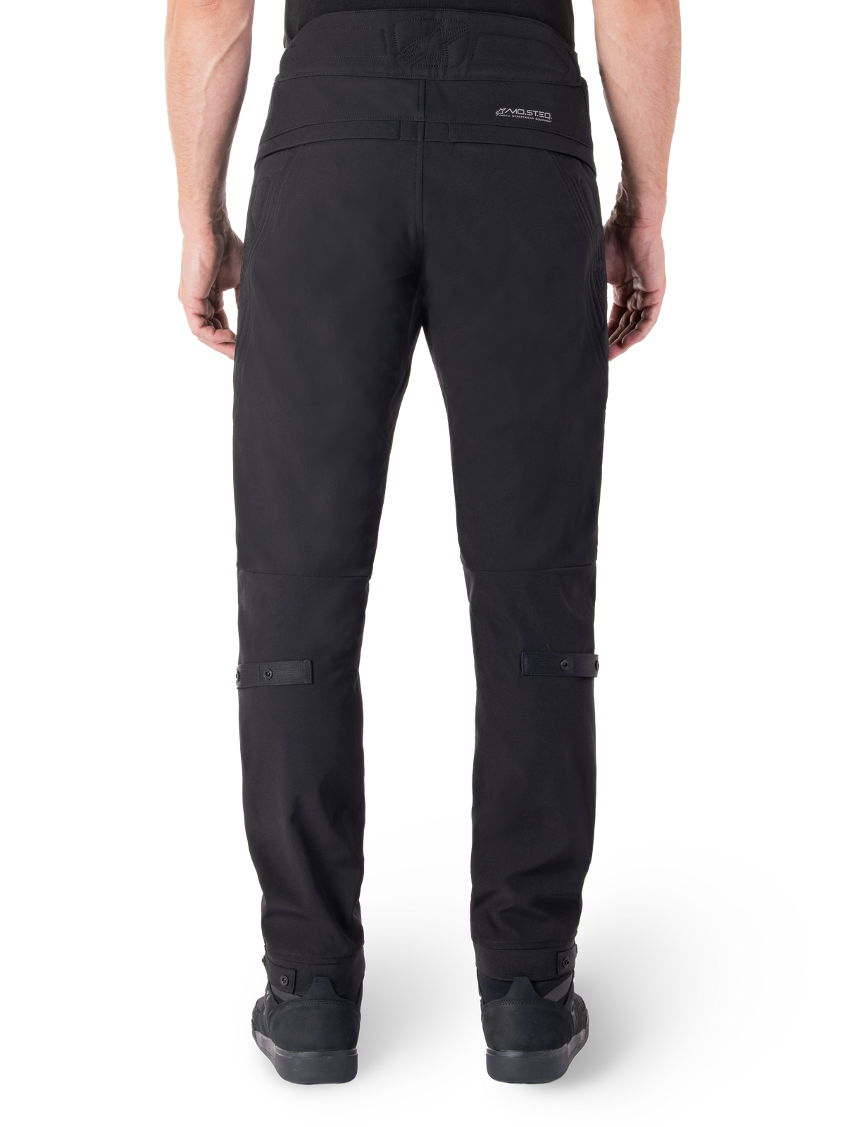 Alpinestars Alden Pants, Black Urban Motorcycle Pants, rear view, featuring reflective MO.ST.EQ. wordmark on the back yoke, slim fit below the knee, and snap button volume adjusters on the calves and cuffs, streetwear-inspired technical textile design.