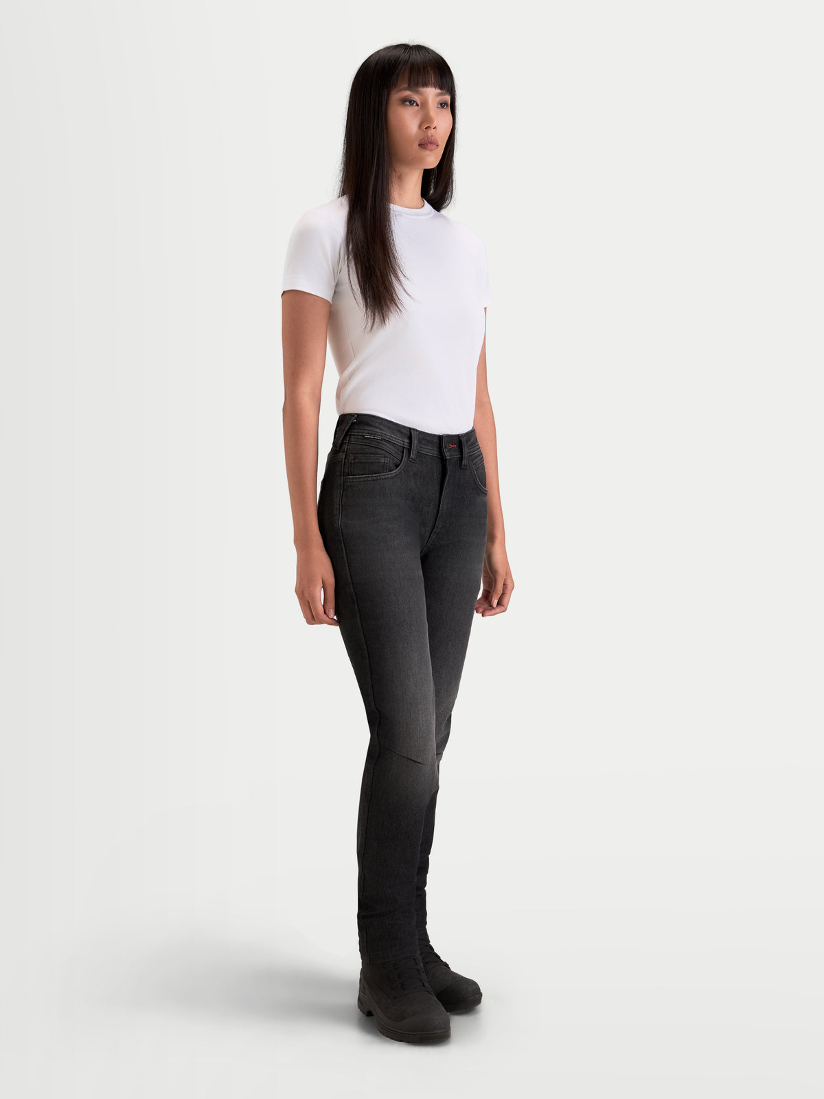 Alpinestars Stella Flex-AST 7 Denim Pants Short, women's urban motorcycle riding jeans in faded black, worn by a model in a studio setting, featuring AA-rated single-layer technical denim and slim protective construction