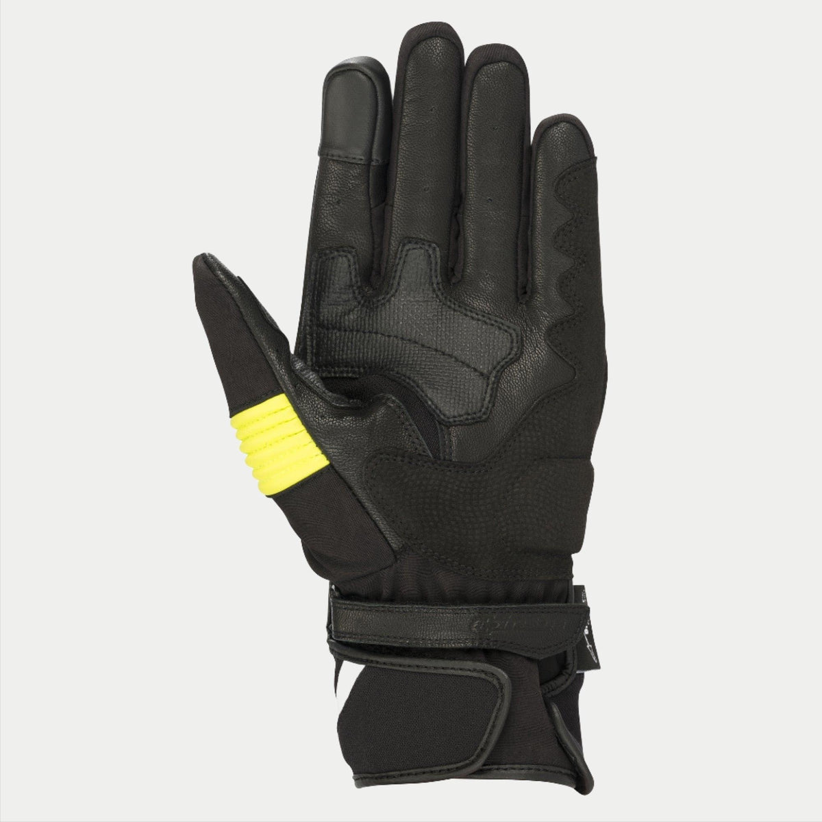 Alpinestars T-SP W Drystar® handskar, svarta och gul fluo, vy av handflatan som visar konstruktion i getskinn med gula fluorescerande detaljer på tummen, pekskärmskompatibla fingertoppar och dubbel kardborrestängning vid handleden
