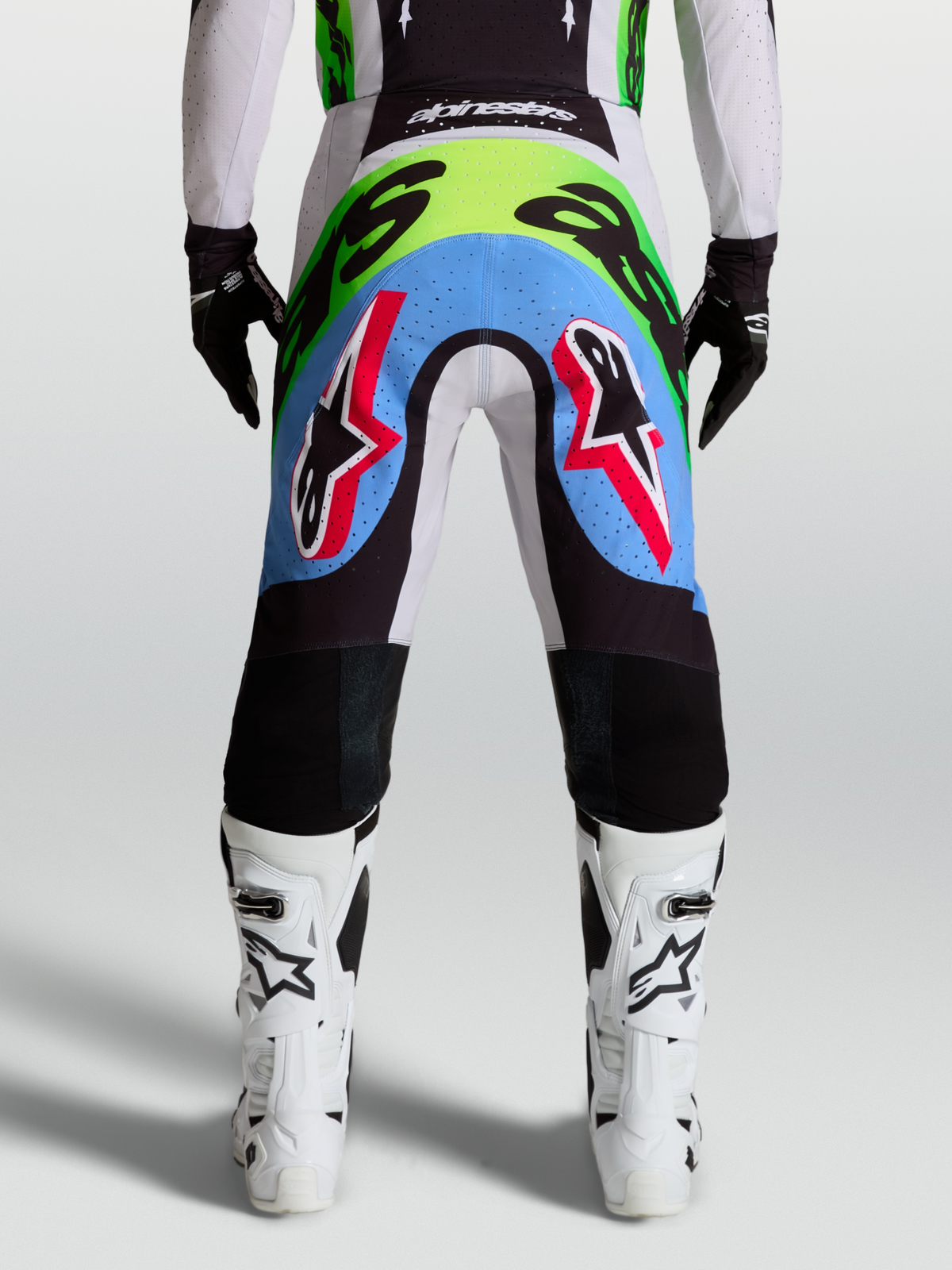 Alpinestars Supertech Dyna motocrossbyxor herr, vy bakifrån i ljuslila och grön fluo med perforerade stretchpaneler