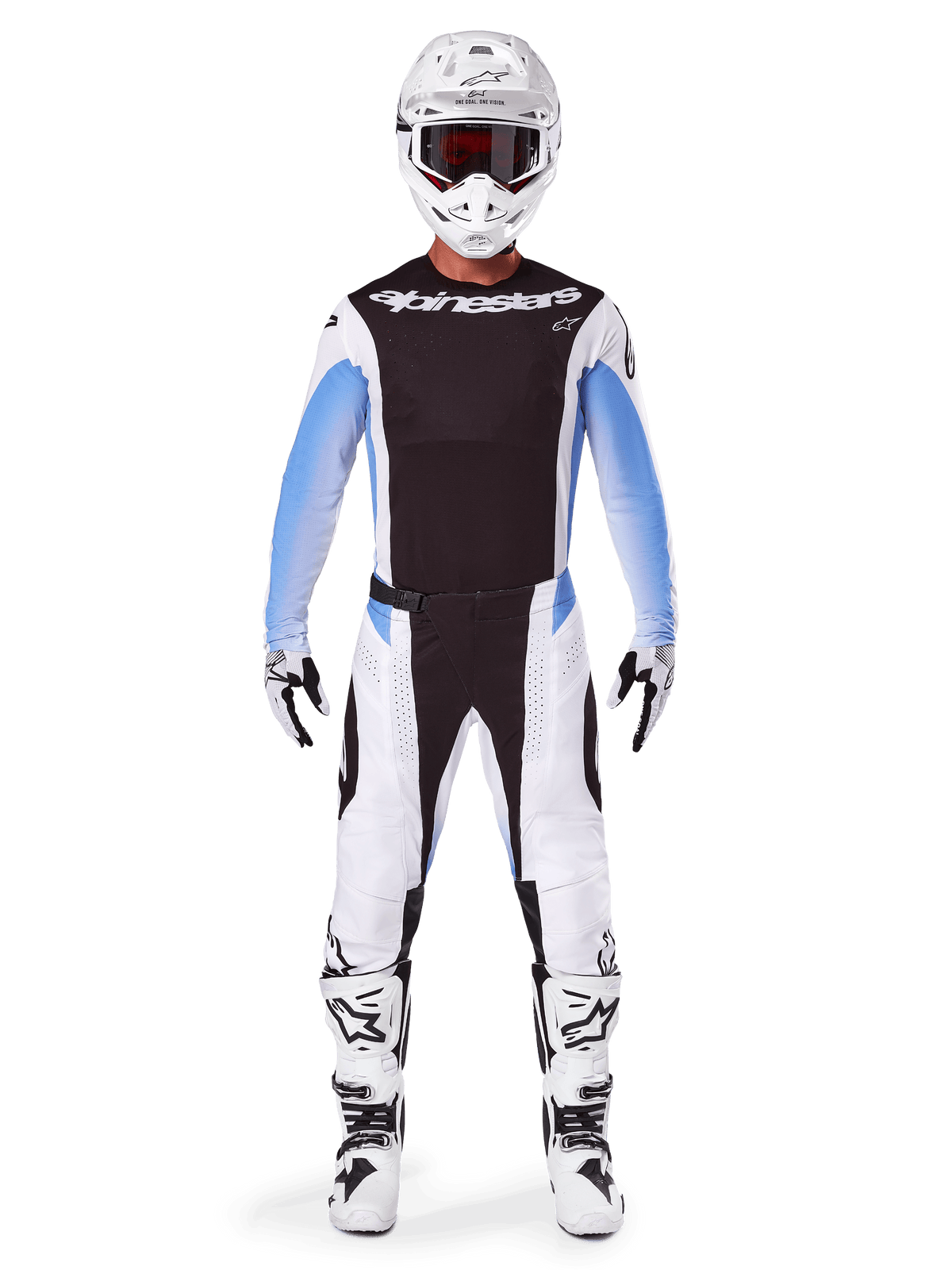 Motocrossförare i Alpinestars 2025 Techstar Melt-byxor, motocrossbyxor, svart och blå, vit och svart flerpanelsdesign med blå detaljer vid höfterna, bärs med matchande vit tröja, vit hjälm, vita handskar och stövlar för en komplett outfit för terrängkörning
