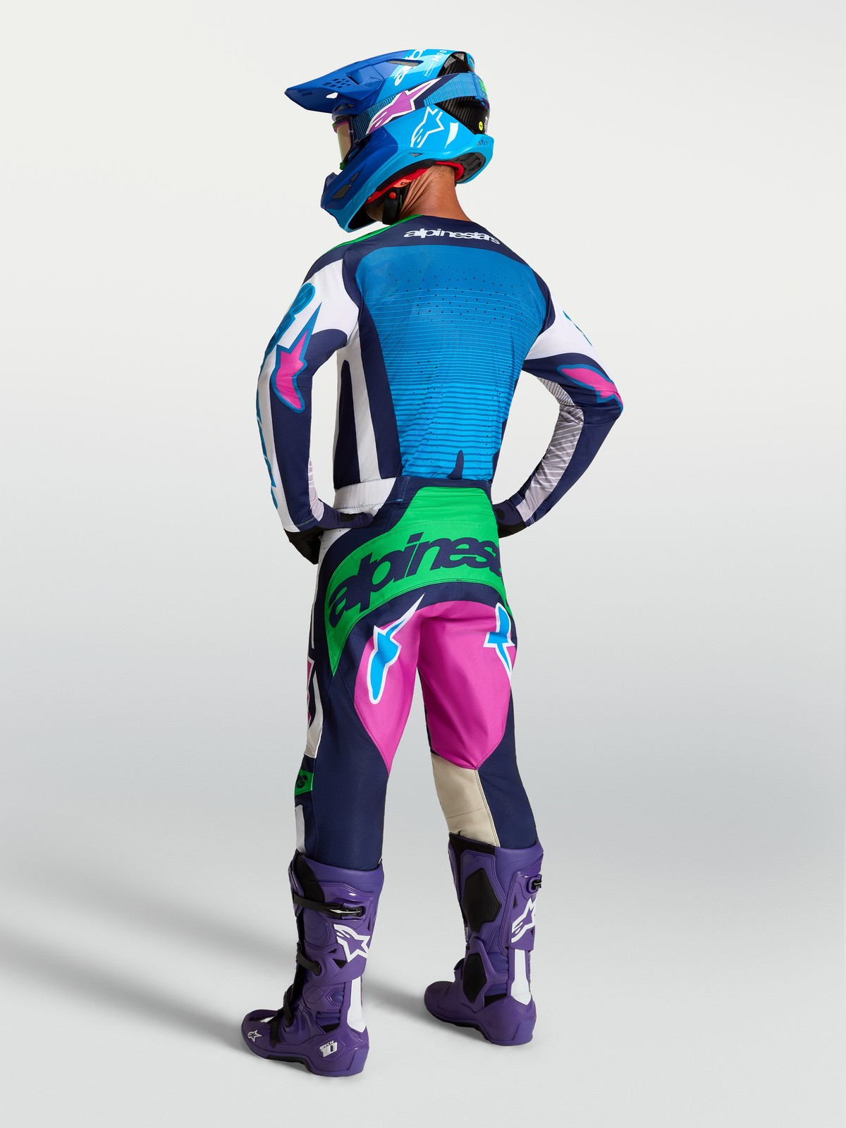 Alpinestars Techstar Maven Gear Set, blått och rosa motocrosskit med neongröna detaljer, bärs av modell bakifrån.