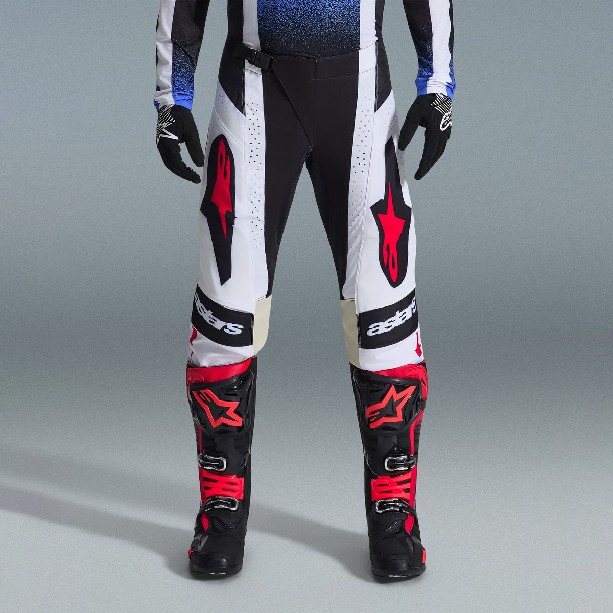 Alpinestars 2026 Techstar Knif Gear Set, Motocross gear, Black and White pants with large Red star logos, worn with black and red racing boots and black gloves, professional athletic fit for off-road performance