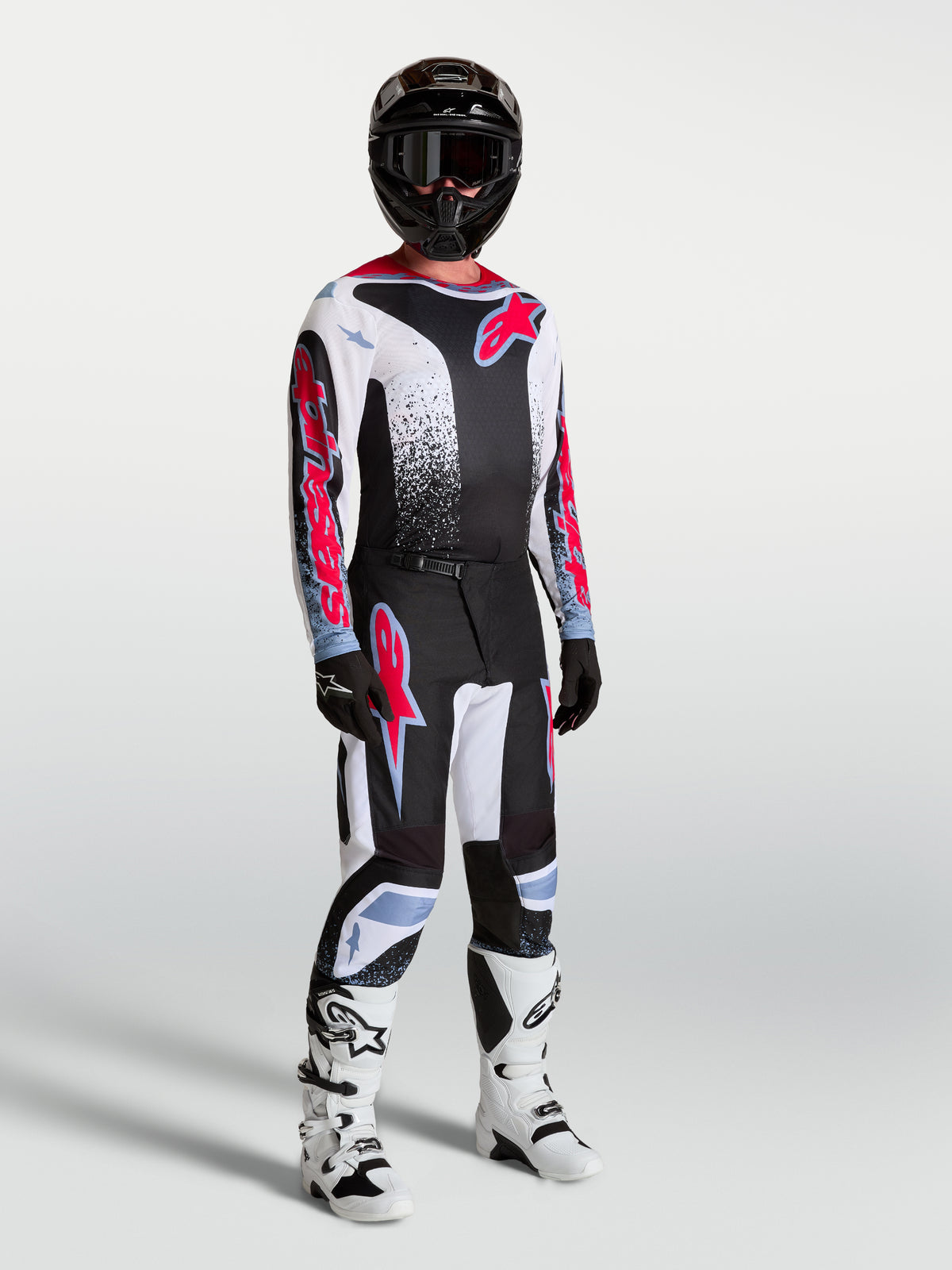 Alpinestars Fluid Drag Pants, men's motocross racing gear set in black and white with red fluo accents.