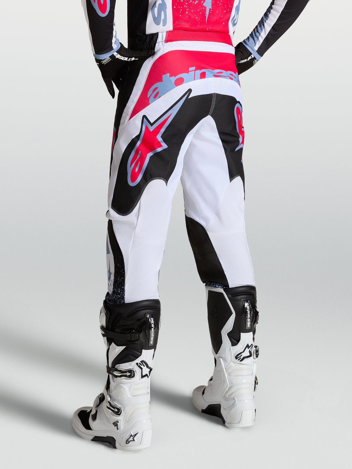 Alpinestars Fluid Drag Pants, men's performance motocross pants in white and black with red and light blue accents.