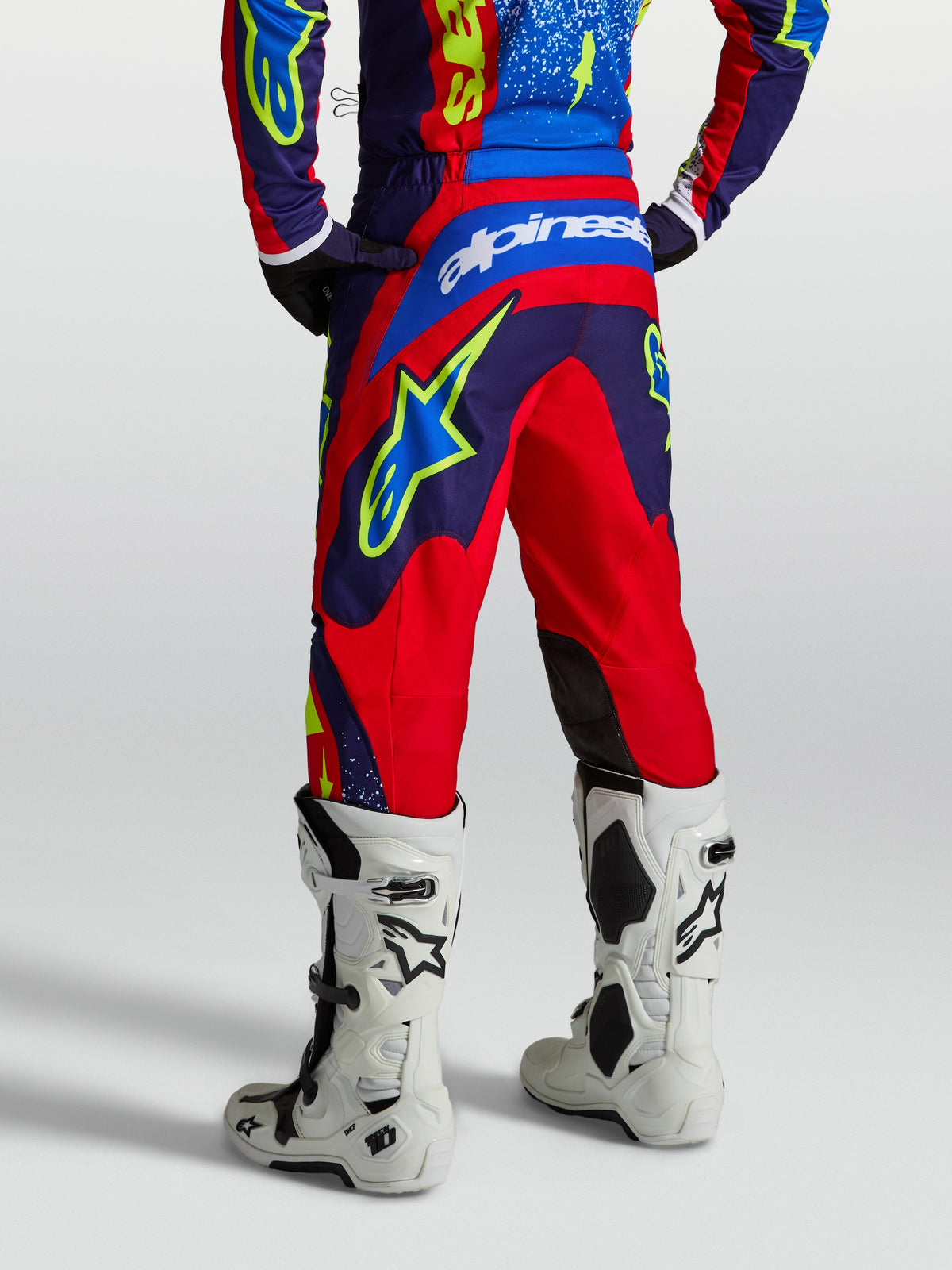 Alpinestars Fluid Drag Pants, navy blue and fire red motocross pants for men with reinforced seat and white logo detail.