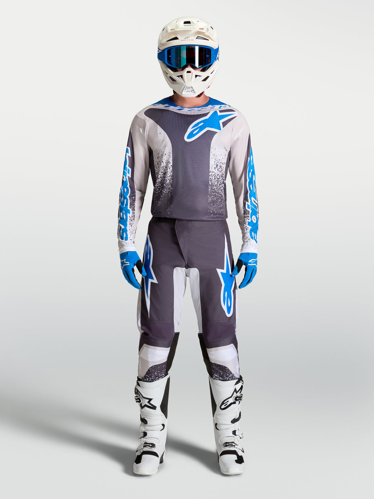 Alpinestars Fluid Drag Pants, Men's Motocross Gear Set in Gray and Blue with matching jersey and white boots.