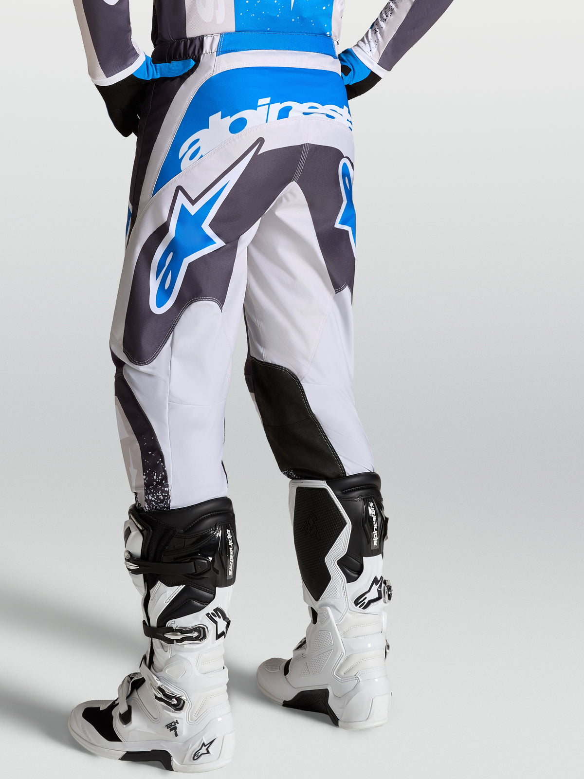 Alpinestars Fluid Drag Pants in Graystone and Ucla Blue, rear view of motocross pants with ergonomic 3D pattern construction.