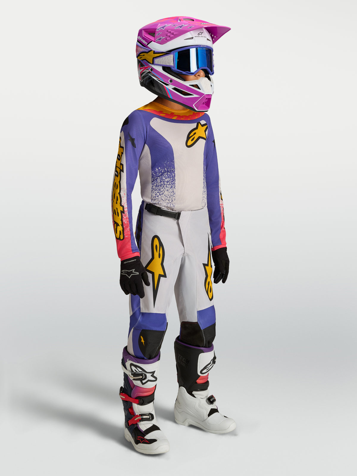 Alpinestars 2027 Ungdom Fluid Drag byxor, blåa och guldiga motocrossbyxor för barn, slitstark textil och ergonomisk passform.