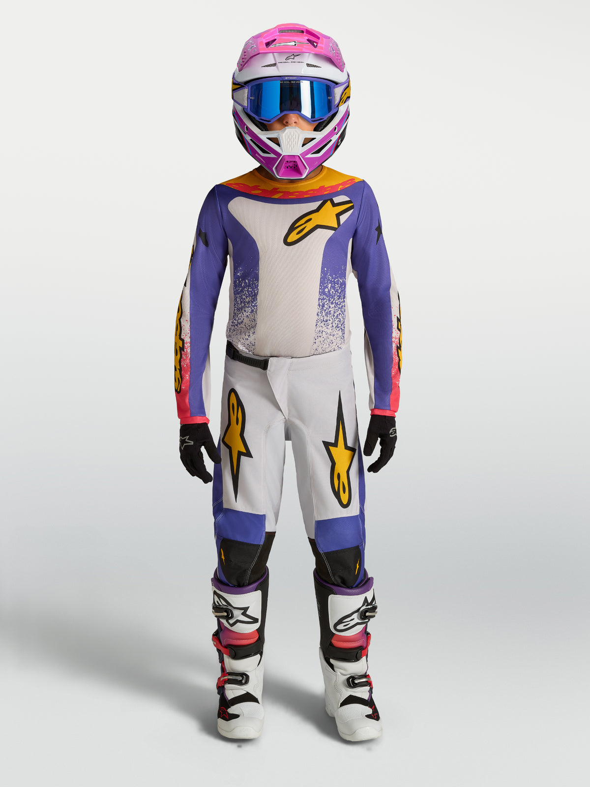 Alpinestars Ungdom Fluid Drag byxor, lila och vit motocrossutrustning för terrängkörning med gulddetaljer.