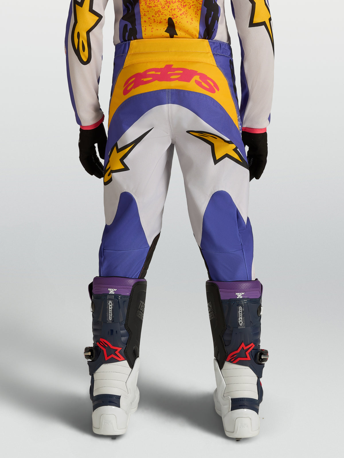 Alpinestars 2027 ungdom Fluid Drag-byxor, blå och guld motocrossbyxor för terrängkörning med 600D-tyg och stjärngrafik.