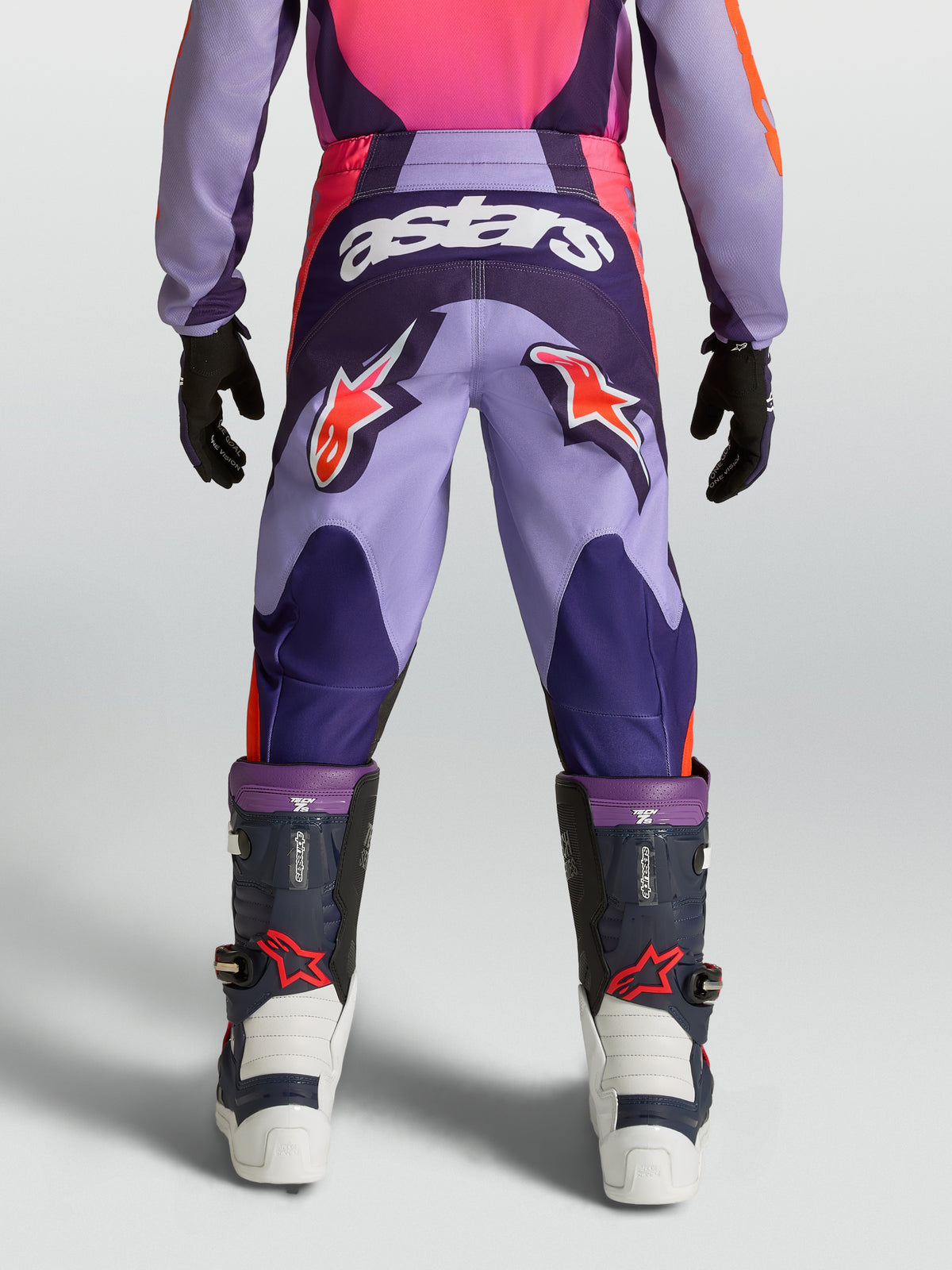 Alpinestars ungdom Fluid Hunt byxor, lila och rosa motocrossbyxor med stjärnlogotyper och hållbar textilkonstruktion.