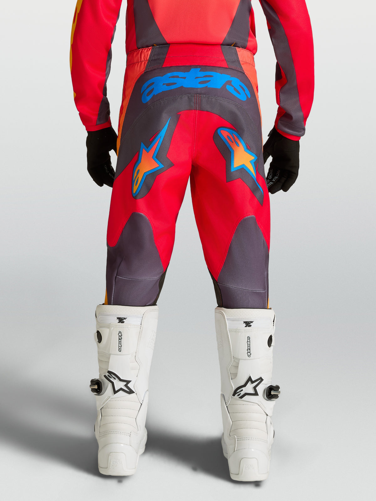 Alpinestars Youth Fluid Hunt Pants, Red and Graystone motocross pants with durable 600D seat and blue star graphics.