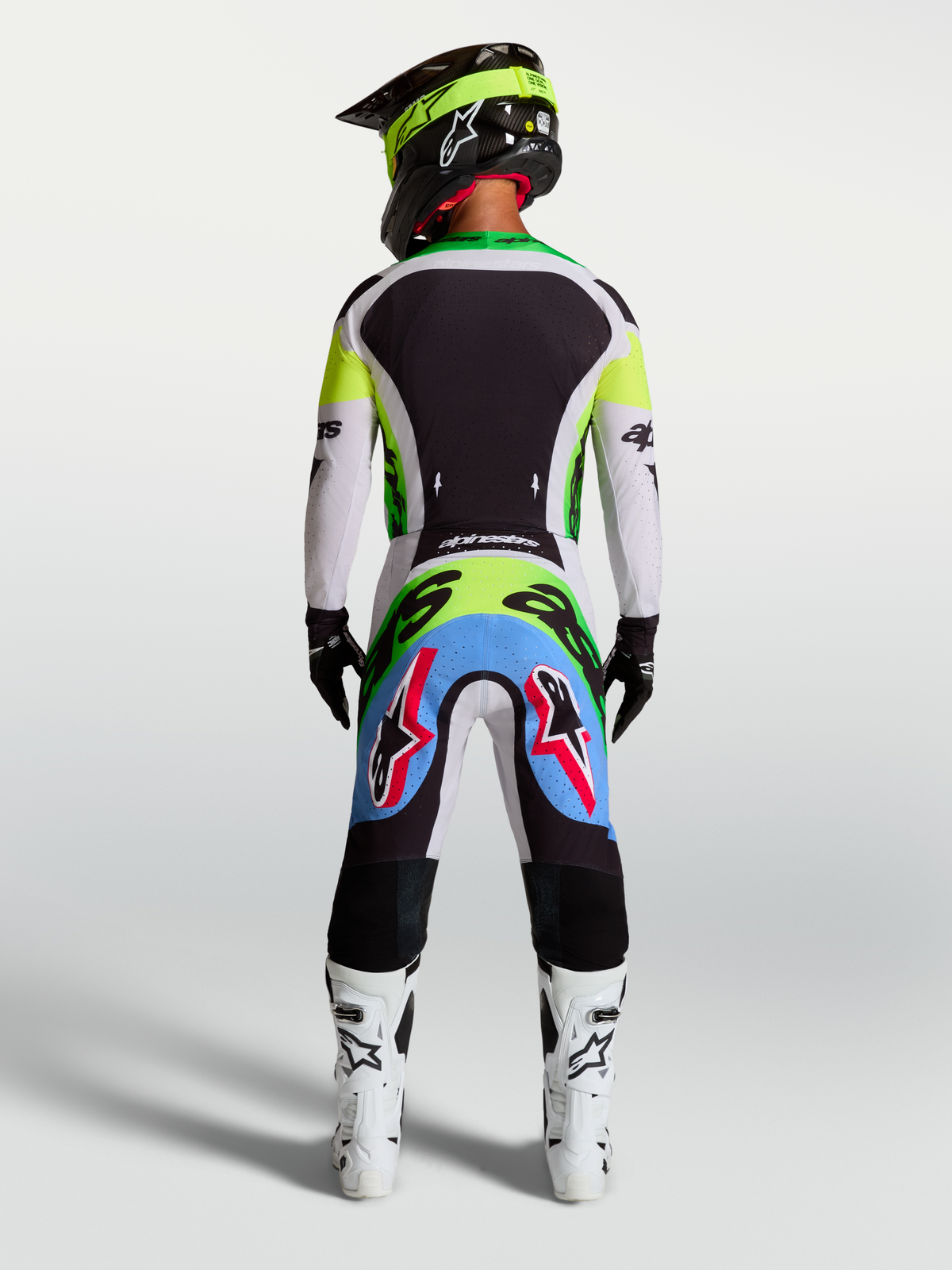 Alpinestars 2027 Supertech Dyna Jersey and Gear Set, men's pro motocross racing outfit in fluo green and black, rear view showing athletic fit and stretch mesh construction.