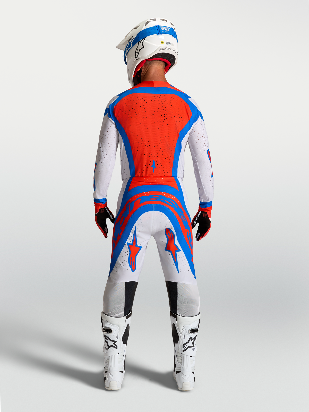 Alpinestars Supertech Vesta Jersey and Gear Set, Cardinal Red and Blue motocross outfit, rear view of men's athletic fit.